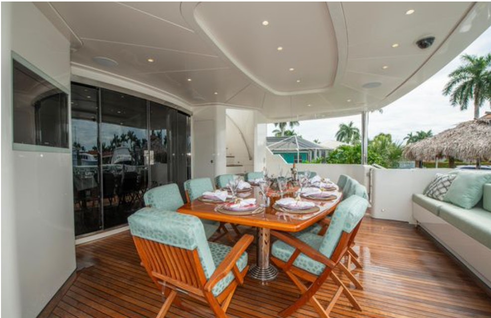 a dining table in a living room aboard HOMECOMING Yacht for Sale