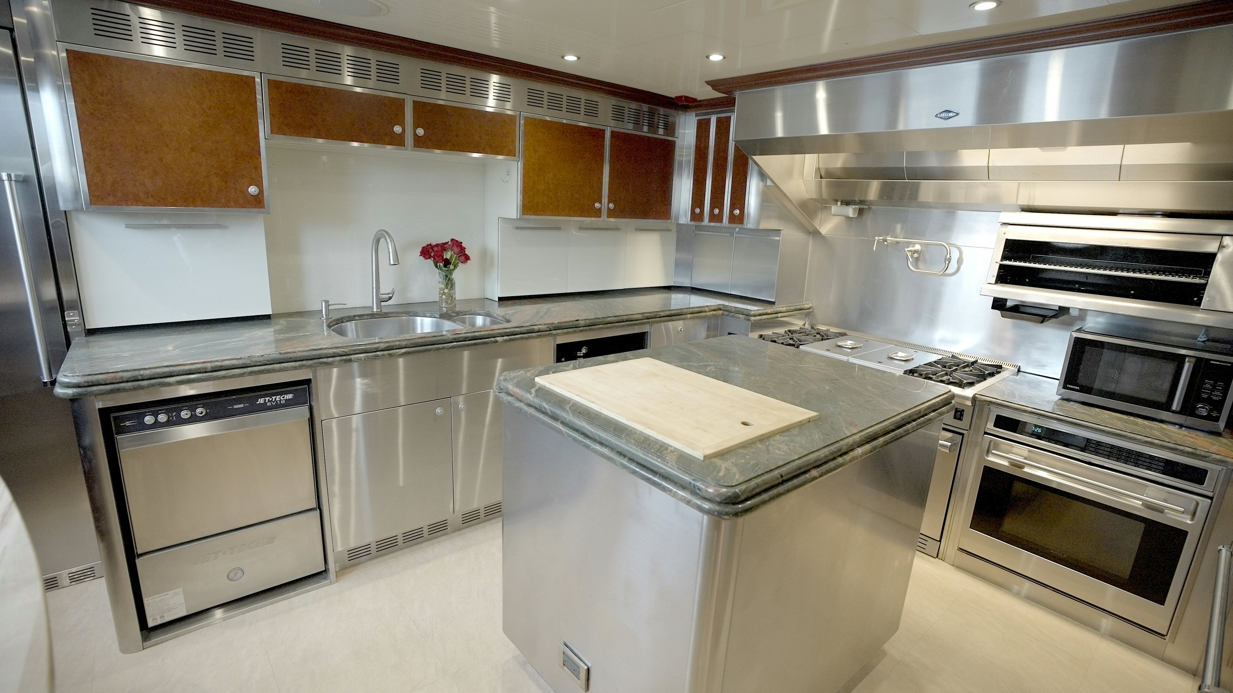 a kitchen with stainless steel appliances aboard HOMECOMING Yacht for Sale