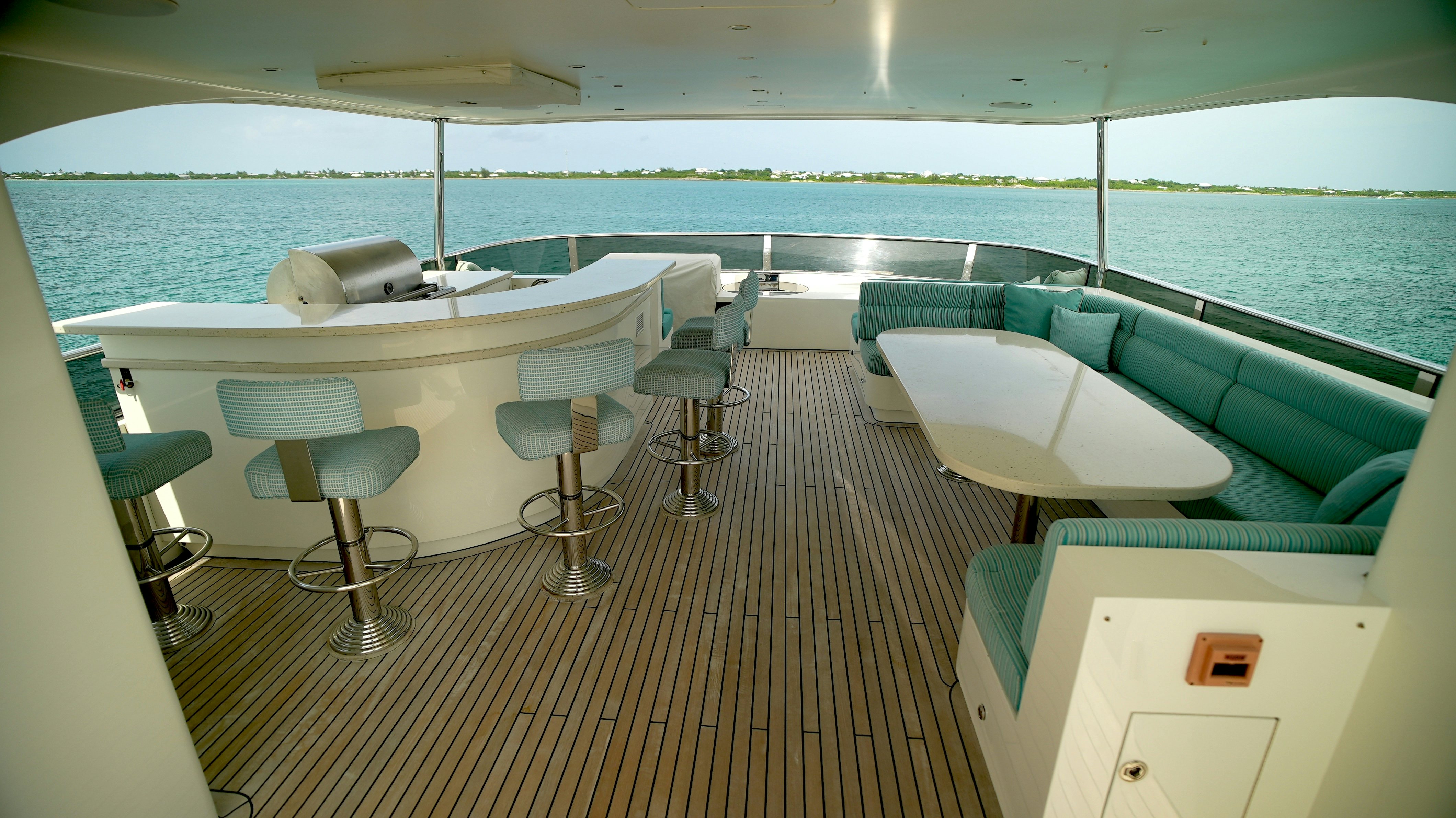 a room with a deck and chairs aboard HOMECOMING Yacht for Sale