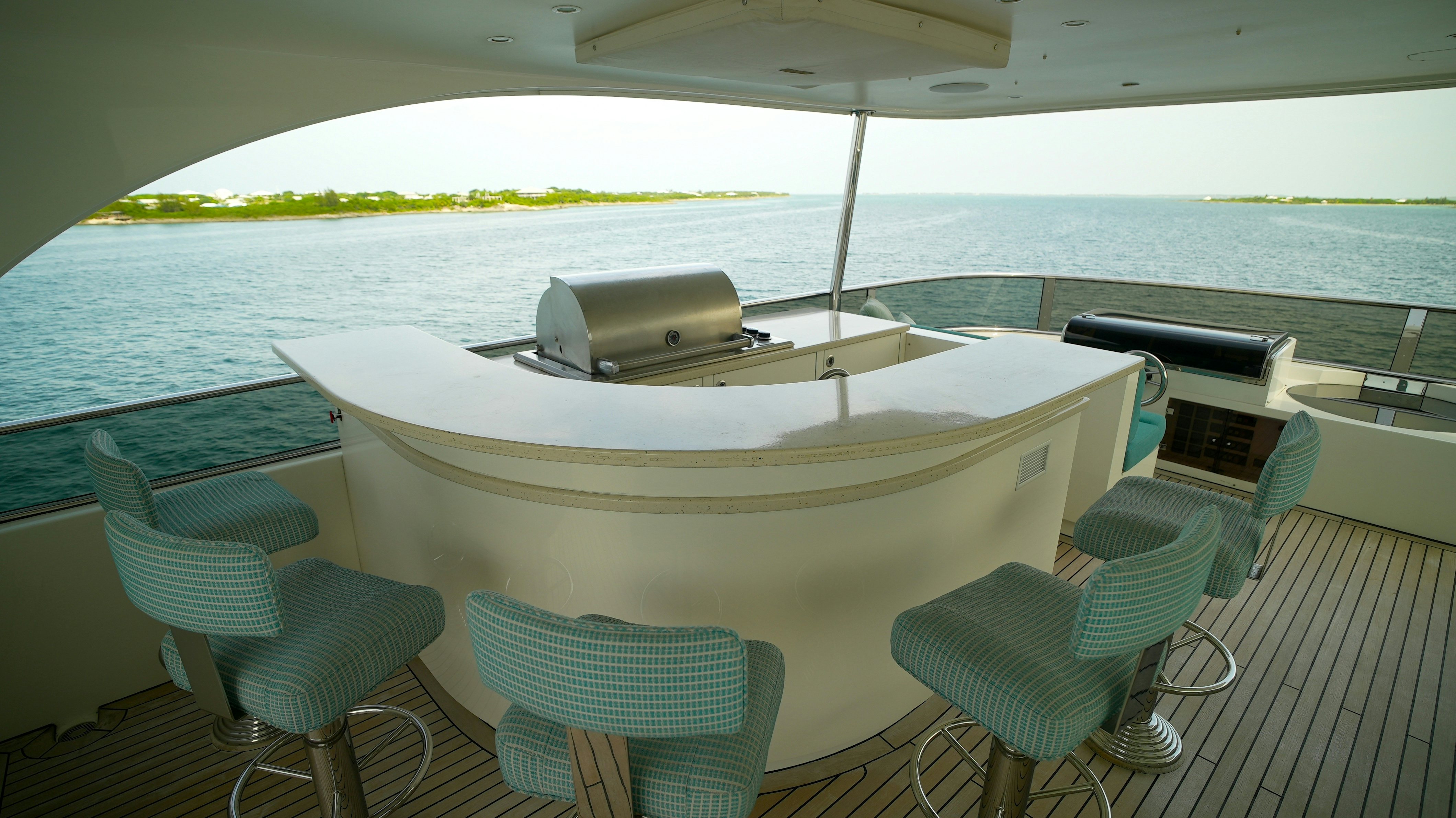 a table and chairs on a deck aboard HOMECOMING Yacht for Sale