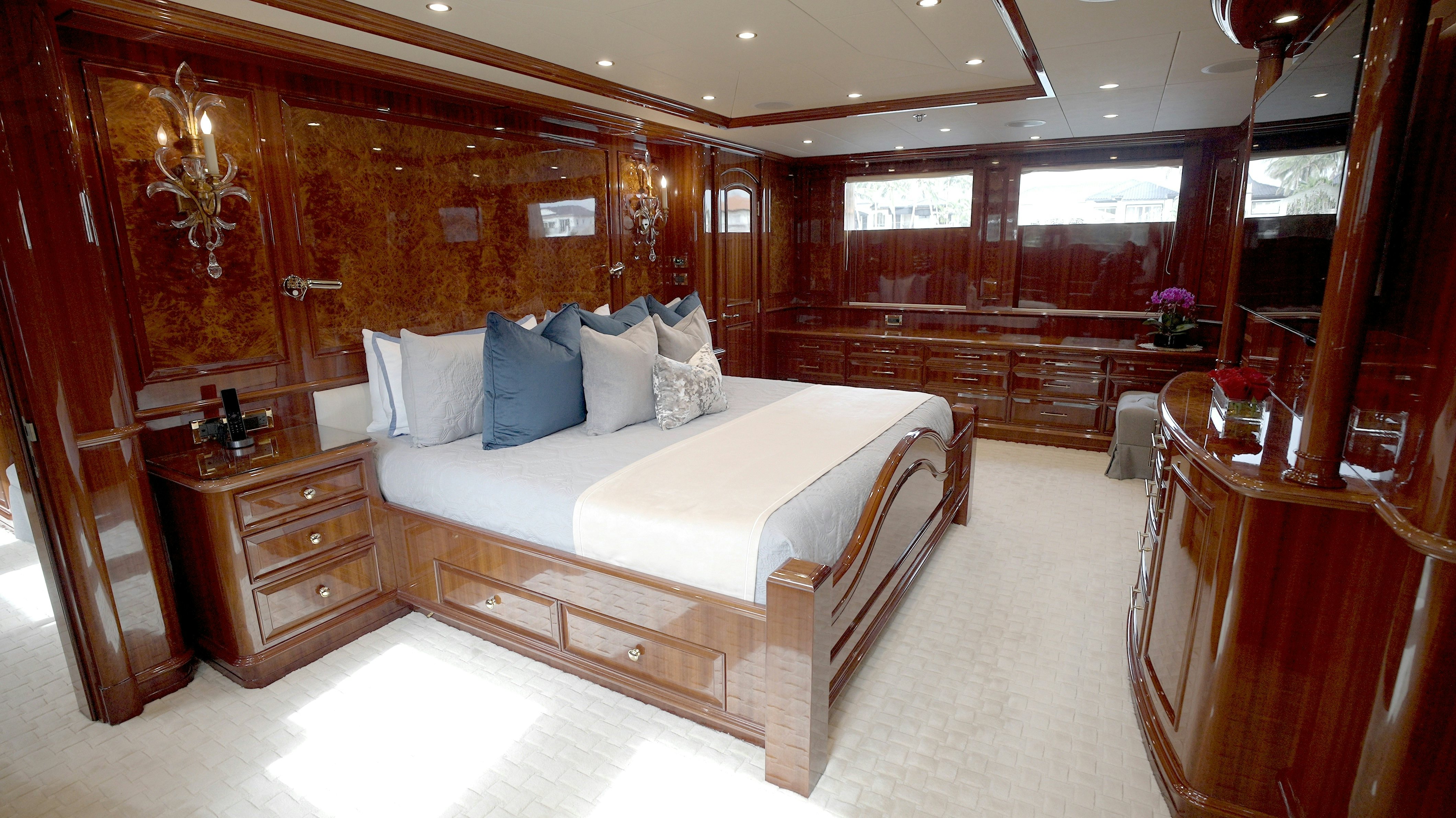a room with a bed and a dresser aboard HOMECOMING Yacht for Sale