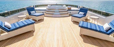 a deck with chairs and tables on it aboard RELENTLESS Yacht for Charter