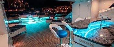 a room with a pool table and chairs aboard RELENTLESS Yacht for Charter