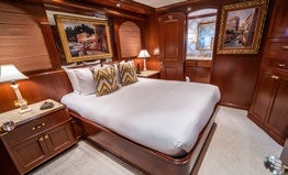 a bedroom with a large bed aboard RELENTLESS Yacht for Charter
