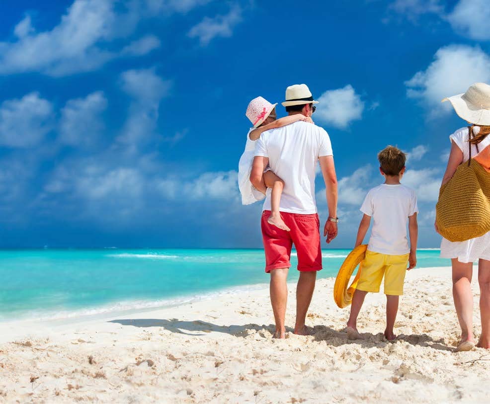 a family walking on a beach aboard RELENTLESS Yacht for Charter