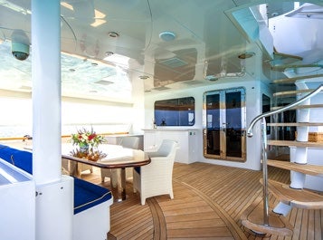 a room with a table and chairs aboard RELENTLESS Yacht for Charter