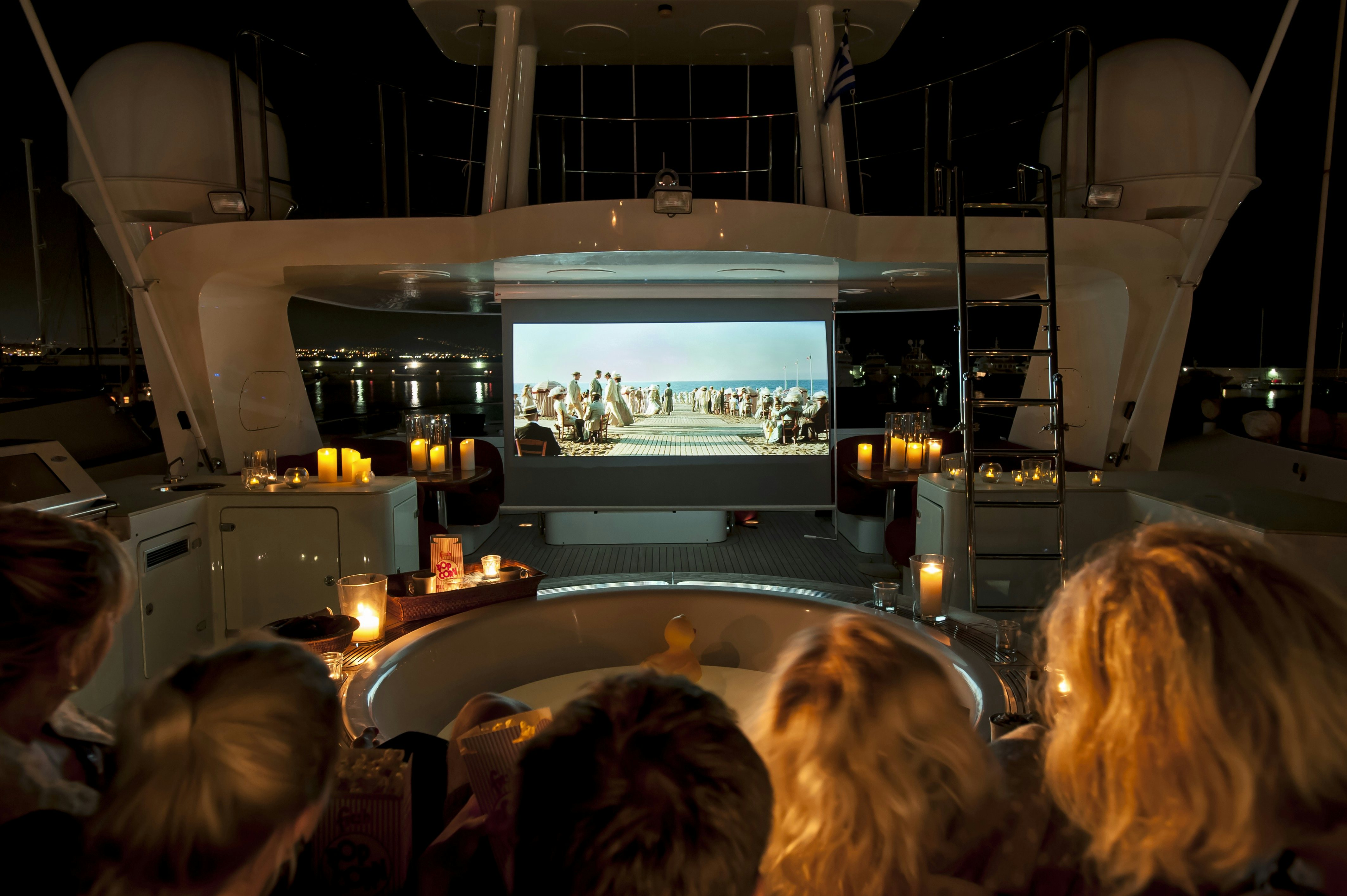 a group of people watching a presentation aboard METSUYAN IV Yacht for Charter