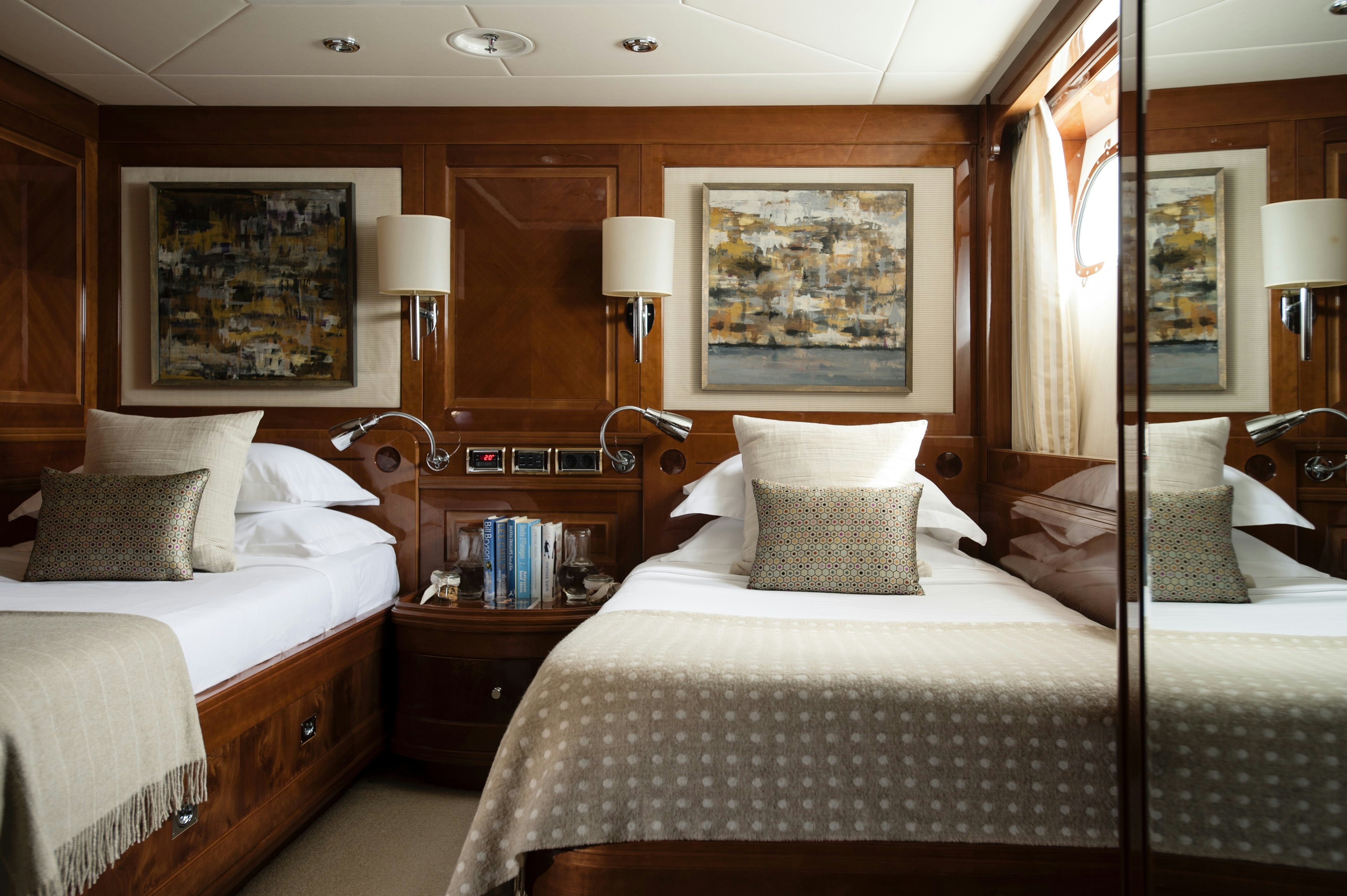 a couple of beds in a hotel room aboard METSUYAN IV Yacht for Charter