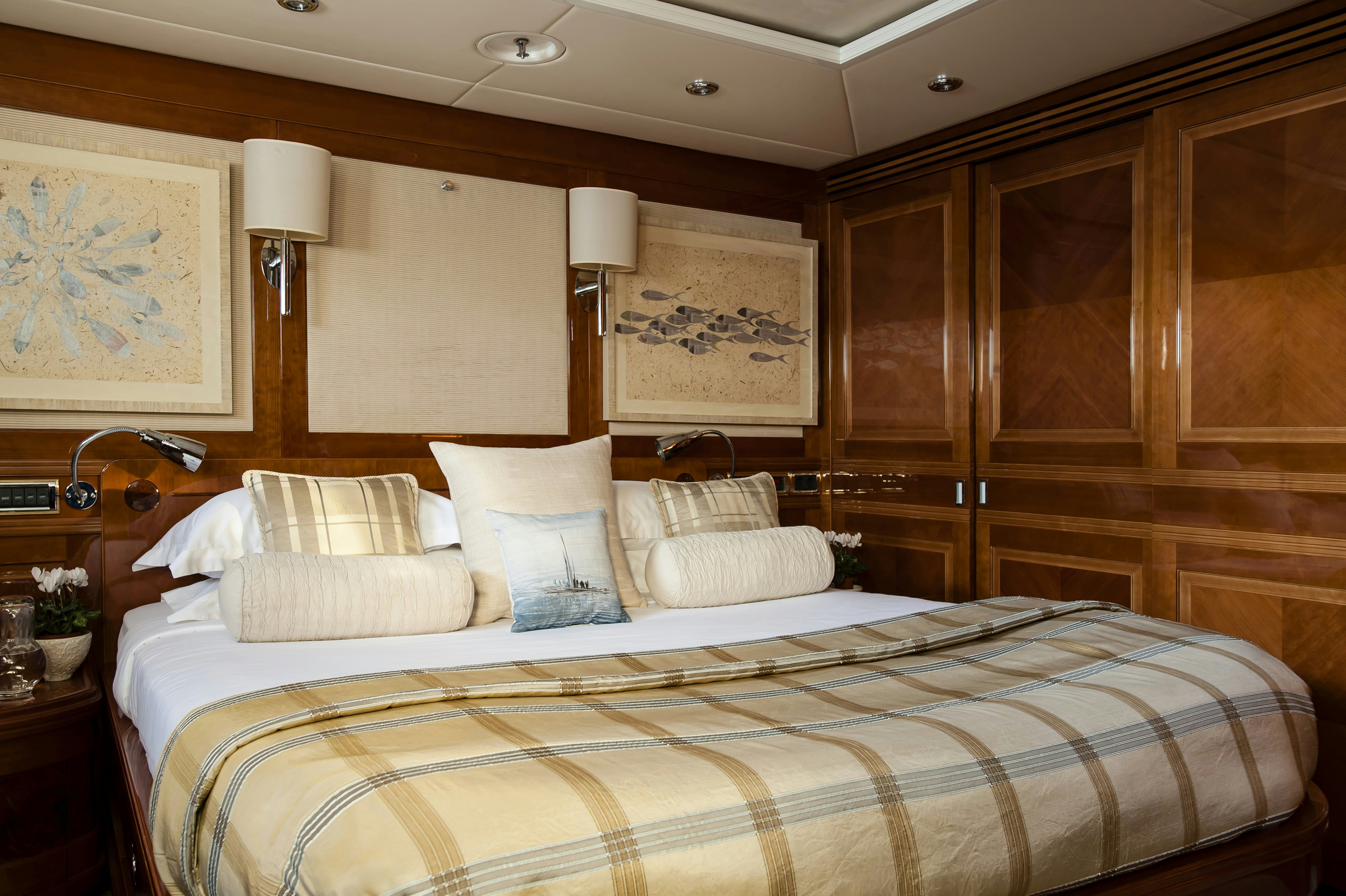 a bed with white pillows aboard METSUYAN IV Yacht for Charter