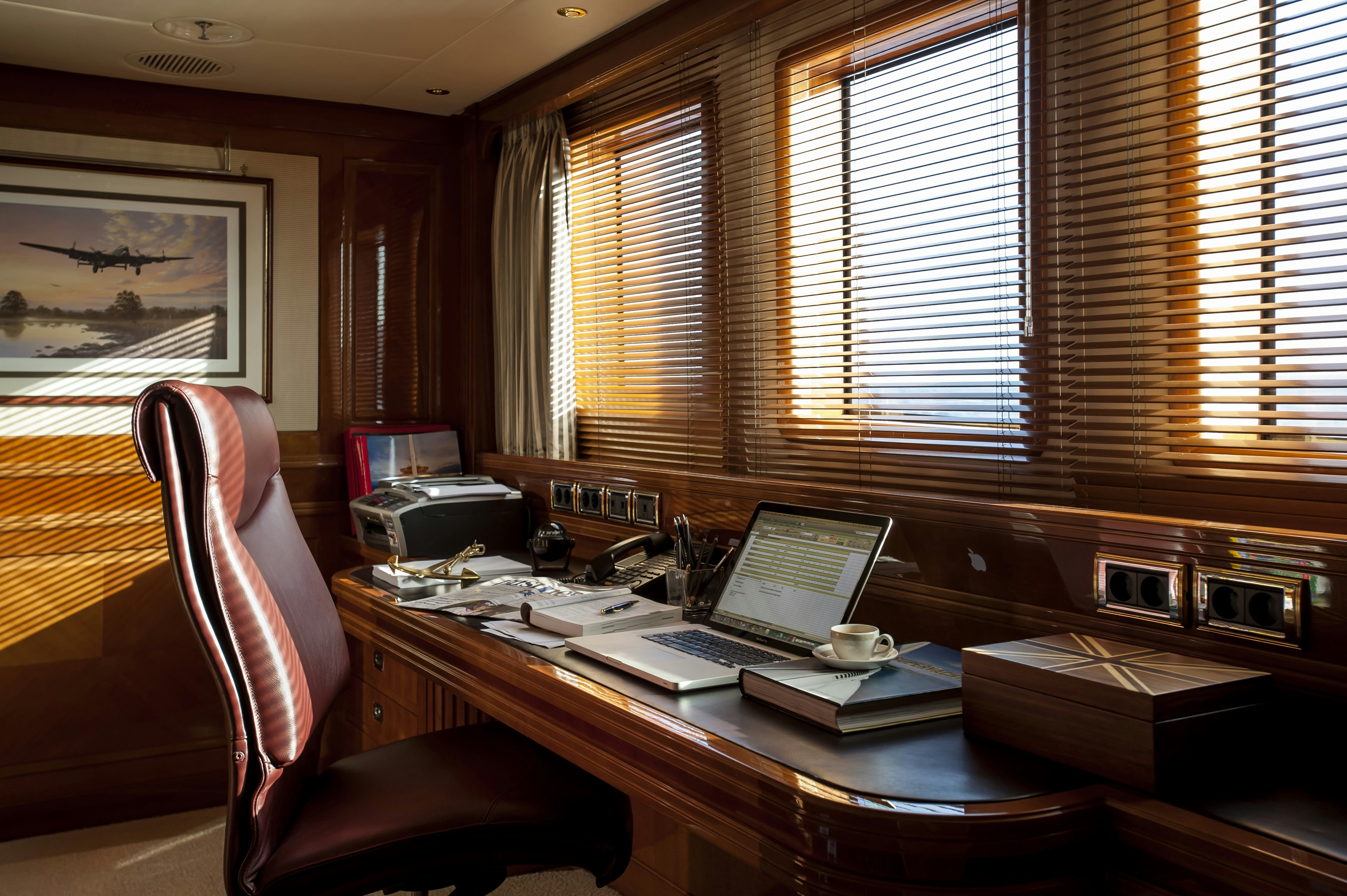a laptop on a desk aboard METSUYAN IV Yacht for Charter