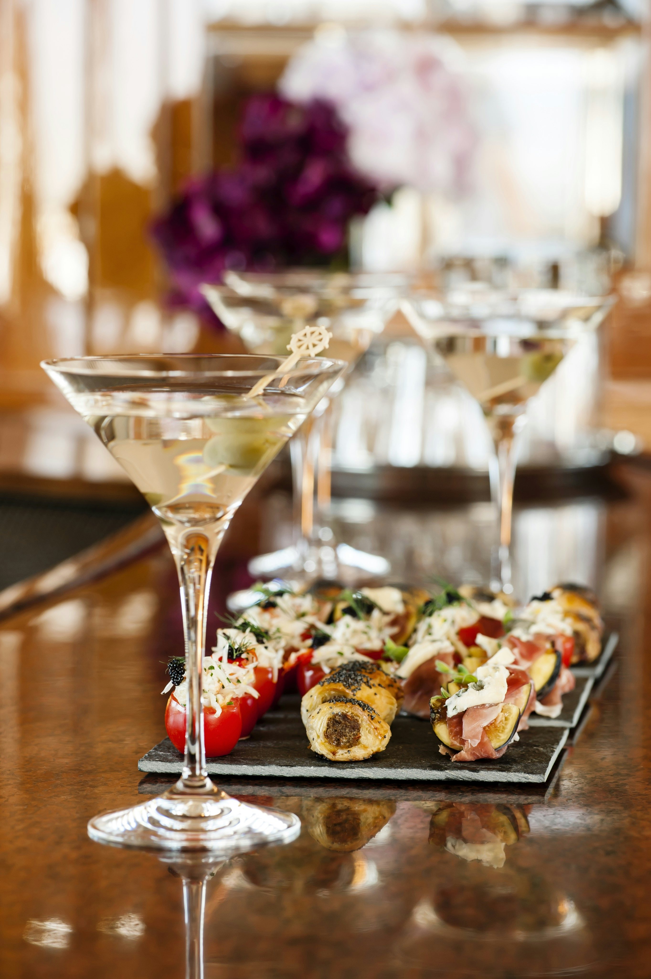 a glass of champagne with a dessert on a table aboard METSUYAN IV Yacht for Charter
