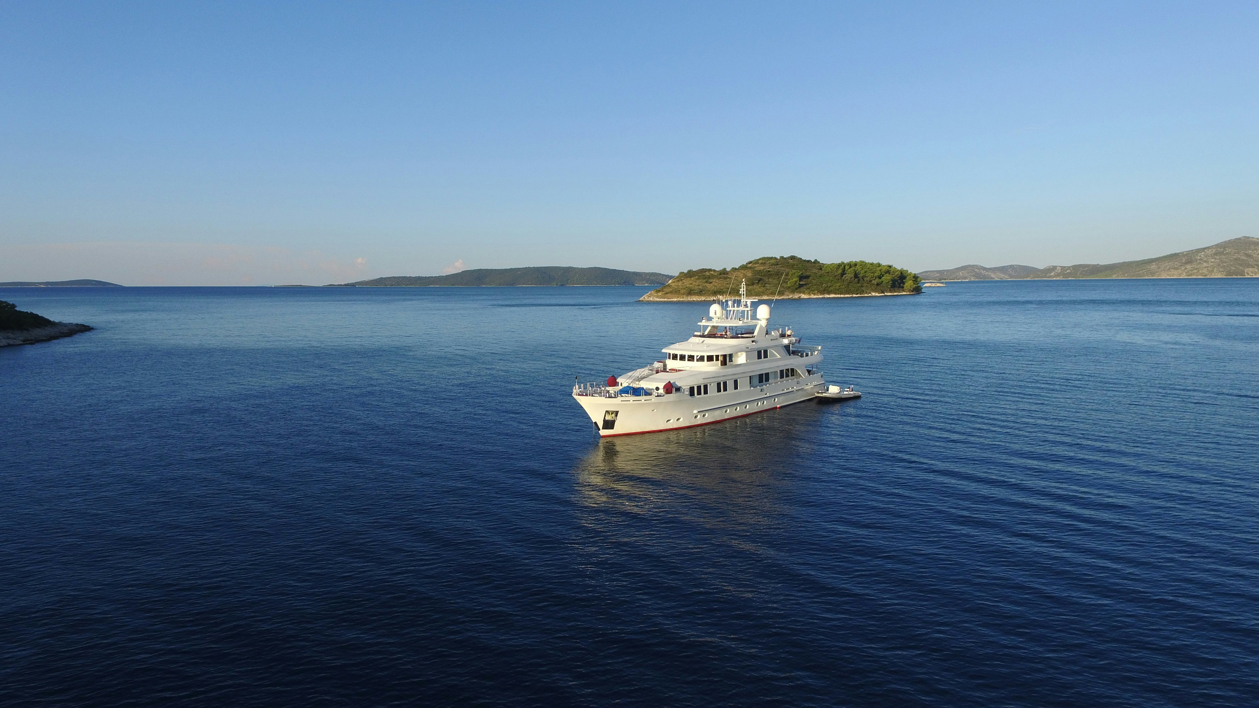 a white boat in the water aboard METSUYAN IV Yacht for Charter