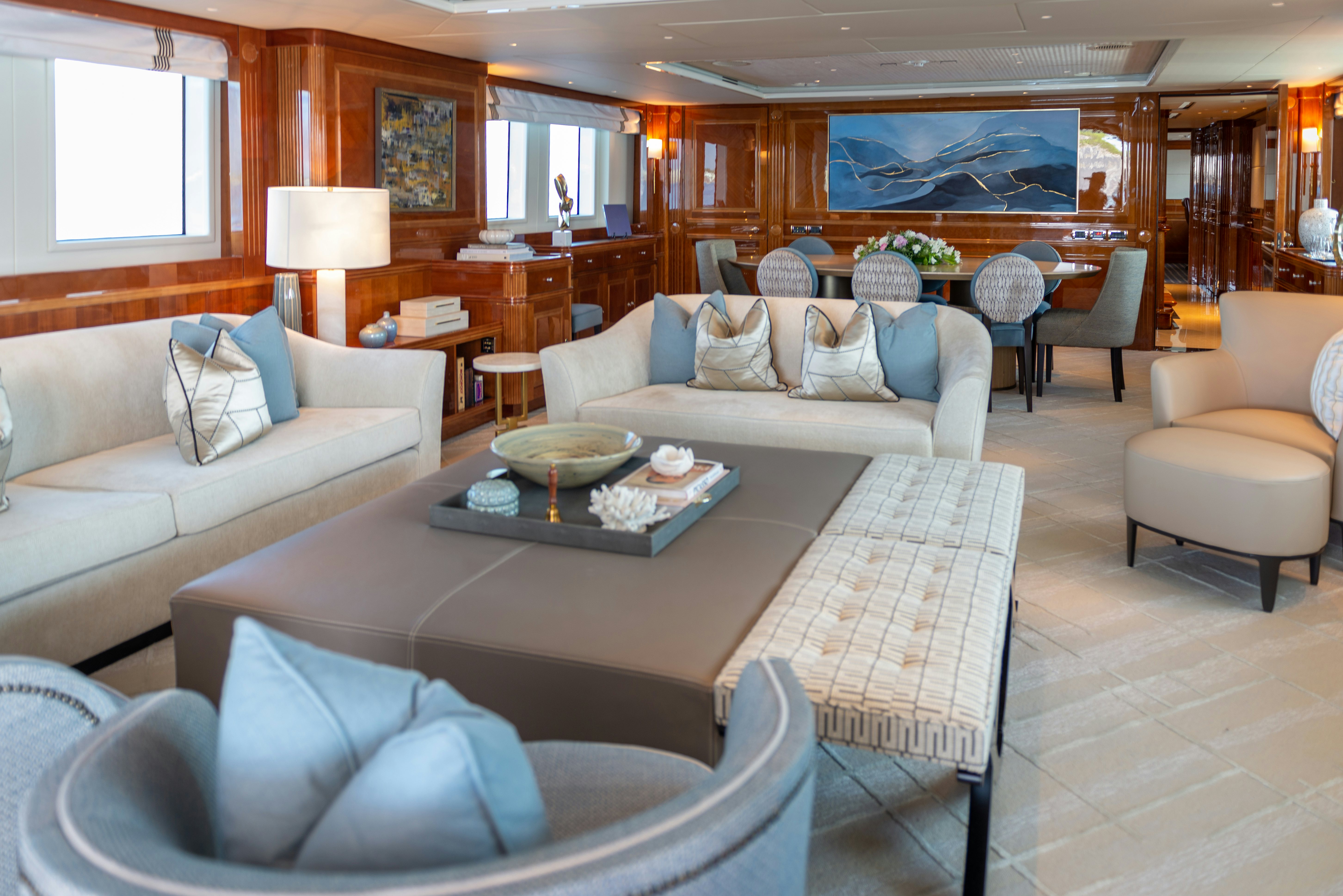 a living room with a couch and a coffee table aboard METSUYAN IV Yacht for Charter