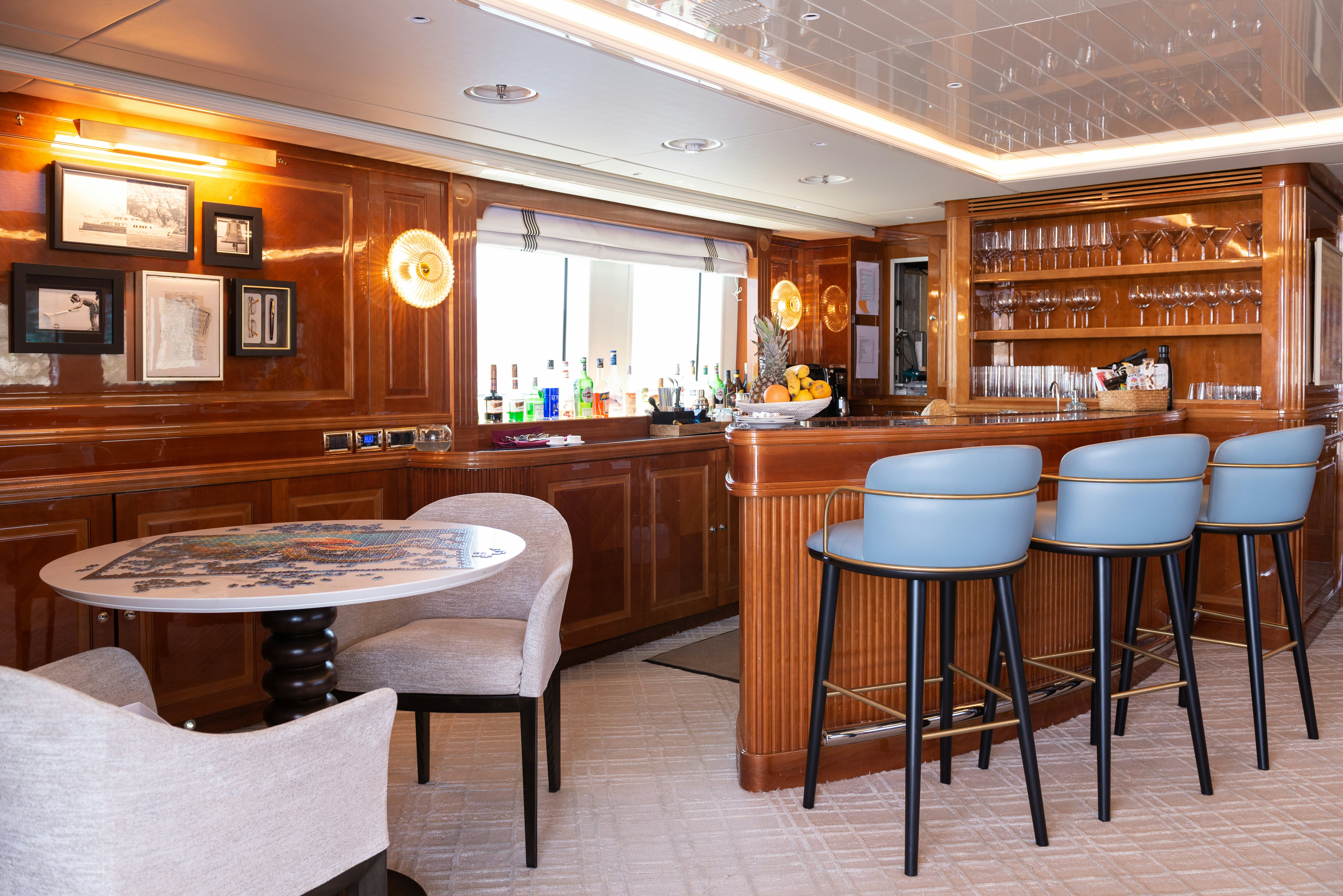 a bar with stools and tables aboard METSUYAN IV Yacht for Charter