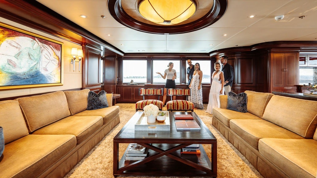 a room with a table and couches aboard LADY BETH Yacht for Charter