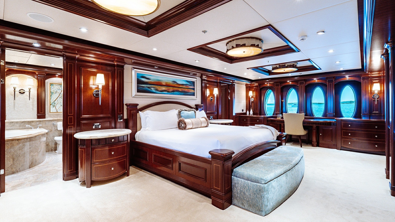 a large bedroom with a bed and a large mirror aboard LADY BETH Yacht for Charter