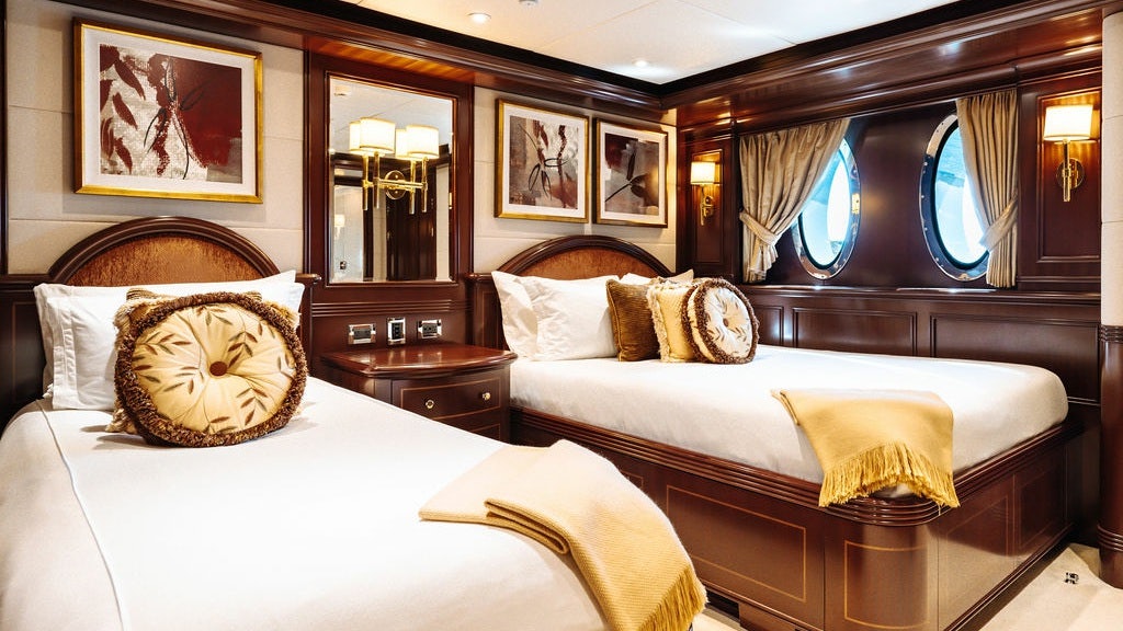 a room with a bed and a mirror aboard LADY BETH Yacht for Charter