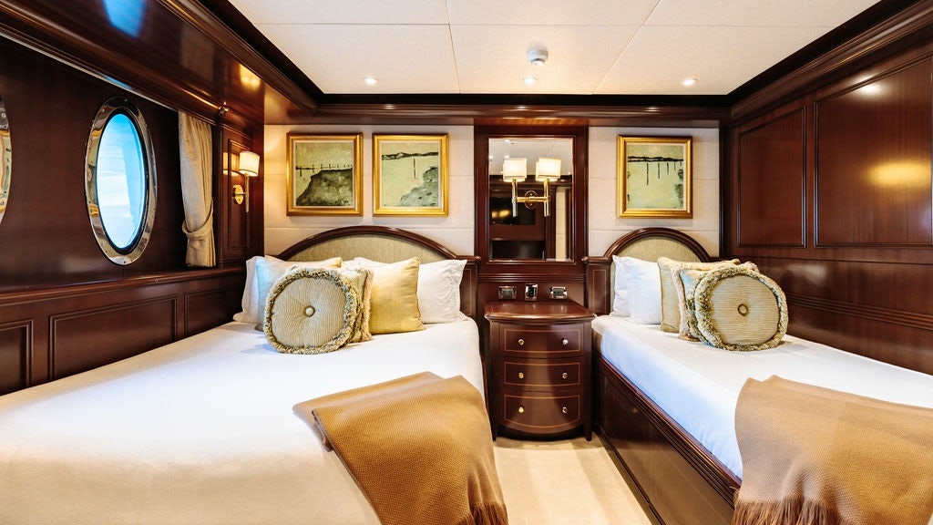 a room with a bed and a mirror aboard LADY BETH Yacht for Charter