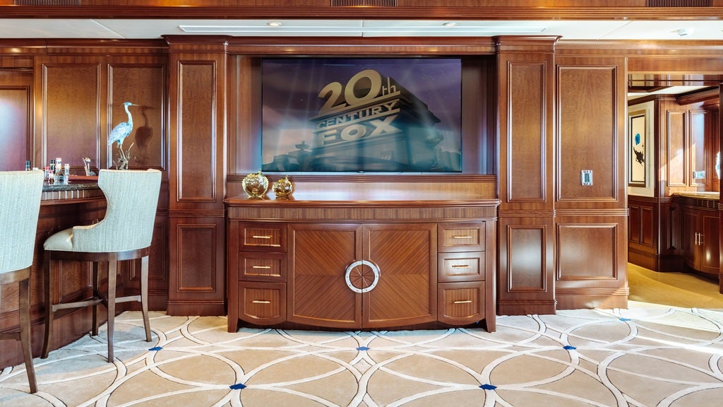 a room with a fireplace and chairs aboard LADY BETH Yacht for Charter