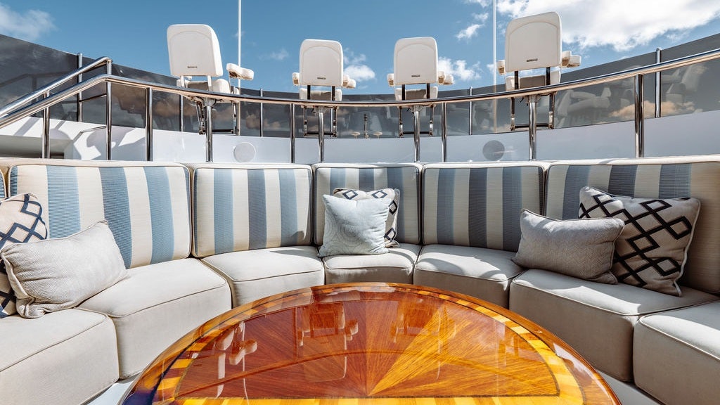 a white couch with pillows on it aboard LADY BETH Yacht for Charter