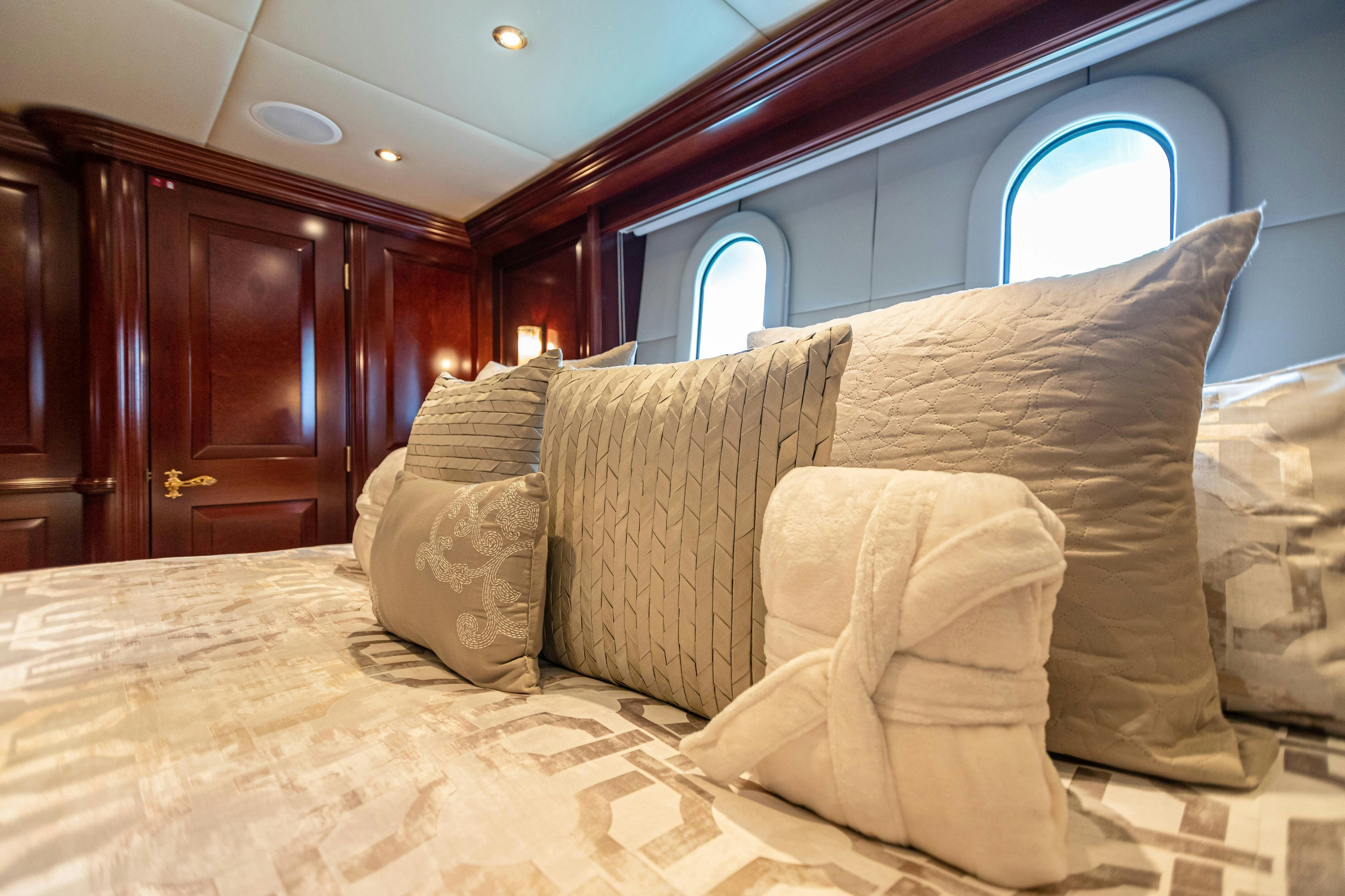 a bed with pillows aboard TCB Yacht for Charter