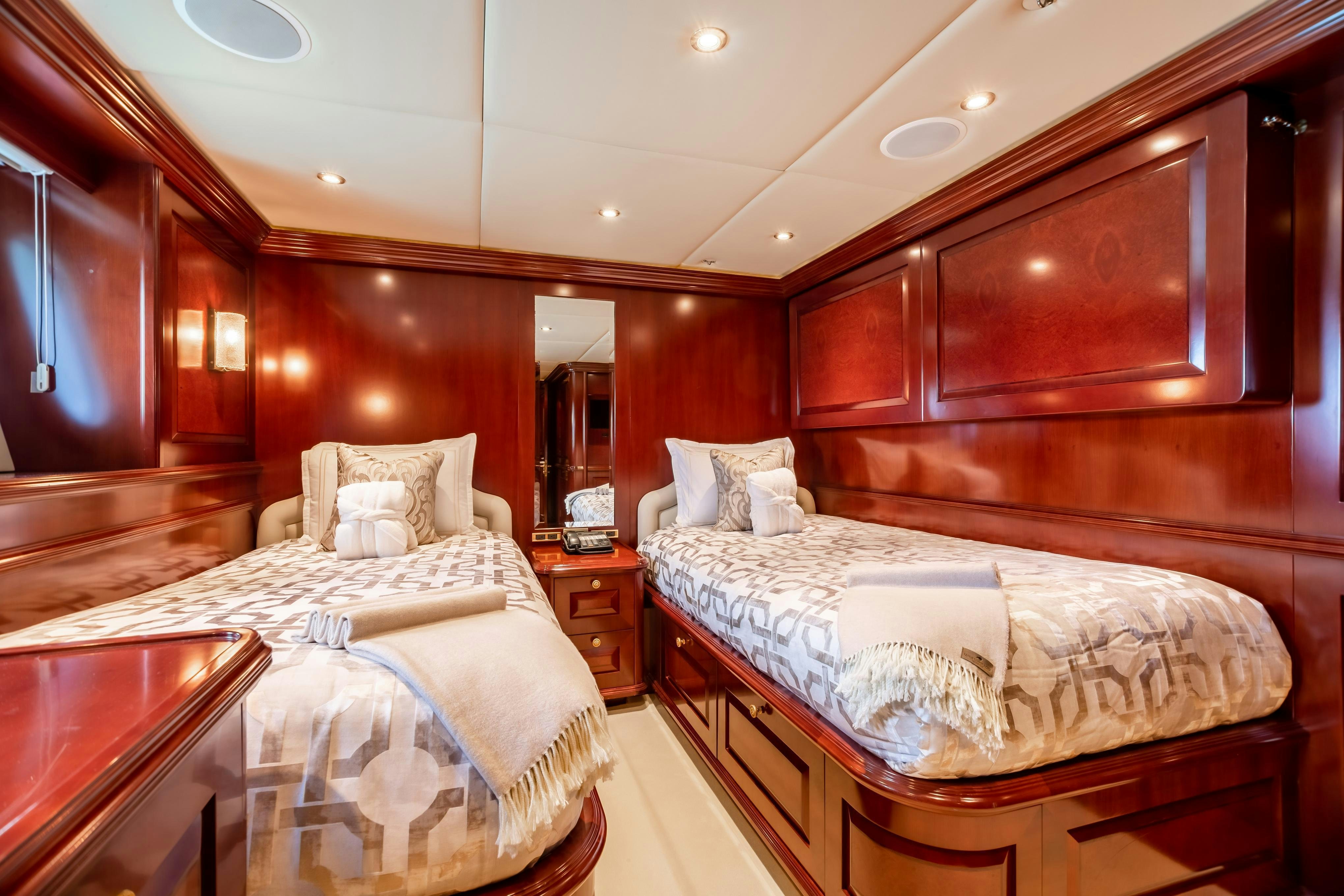 a couple of beds in a hotel room aboard TCB Yacht for Charter