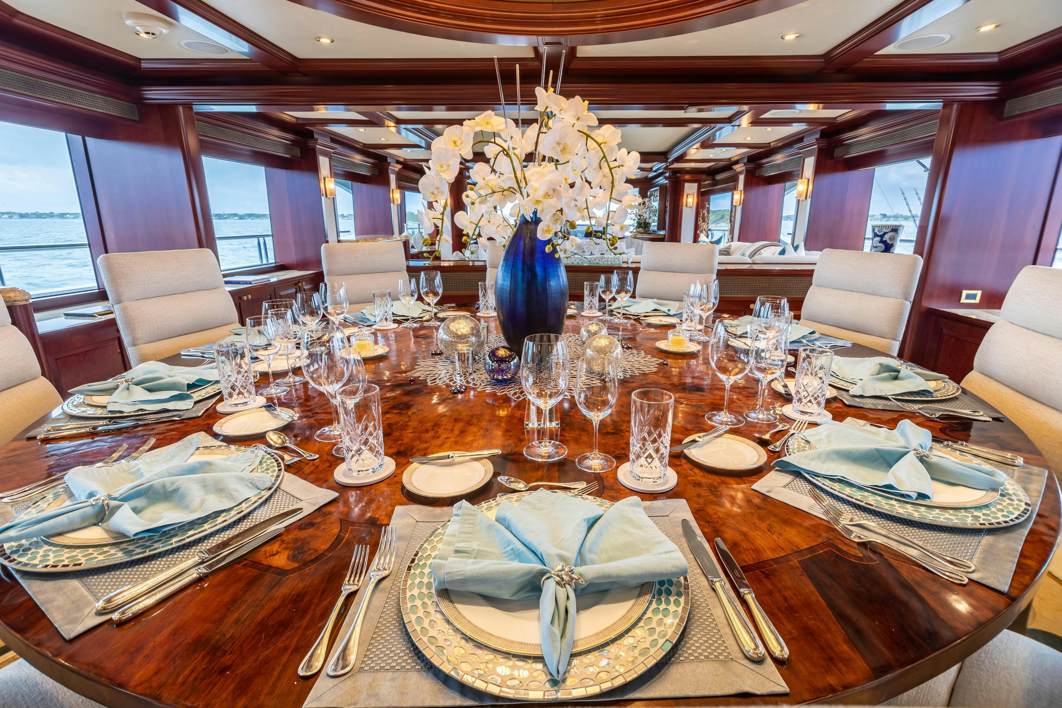 a large dining room with a chandelier aboard TCB Yacht for Charter