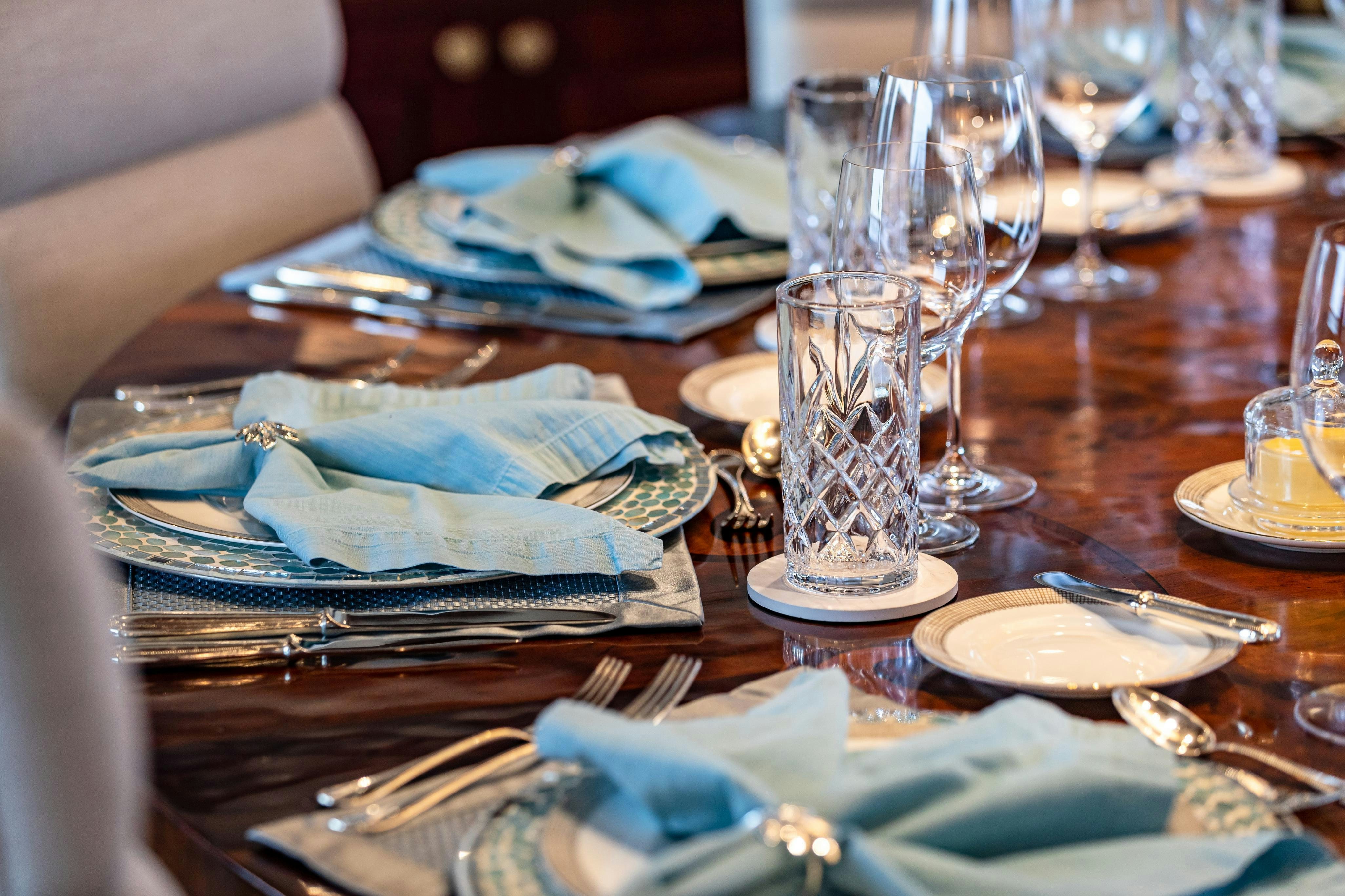 a table with a plate and silverware on it aboard TCB Yacht for Charter