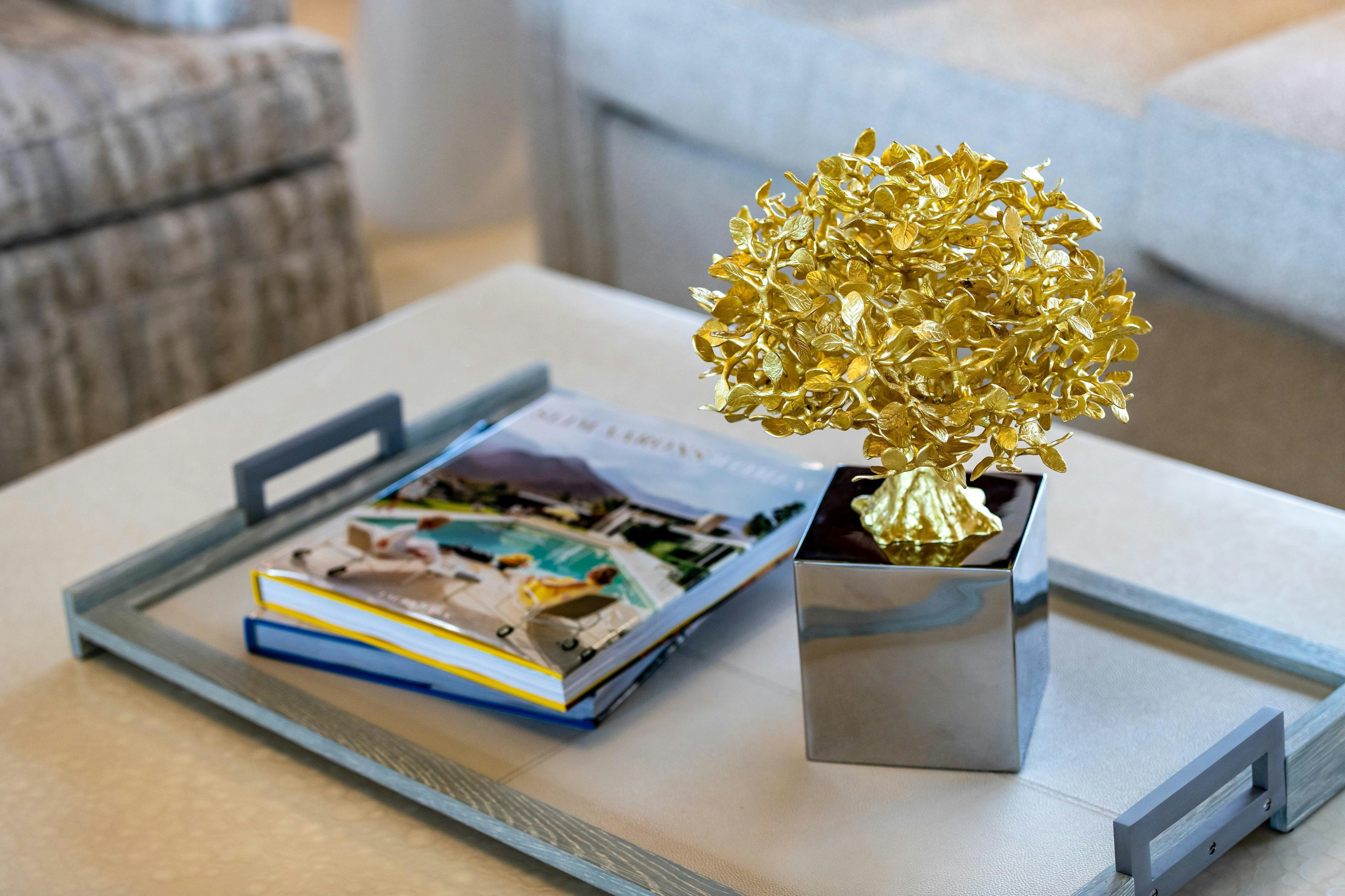 a vase of flowers and a book on a table aboard TCB Yacht for Charter