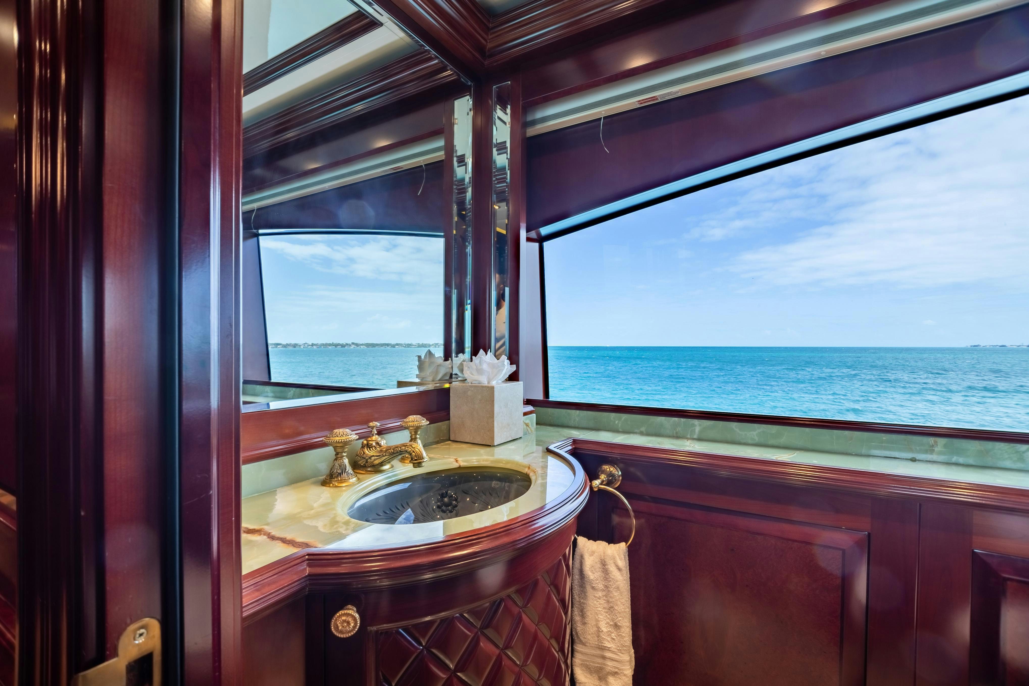 a bathroom with a sink and a window aboard TCB Yacht for Charter
