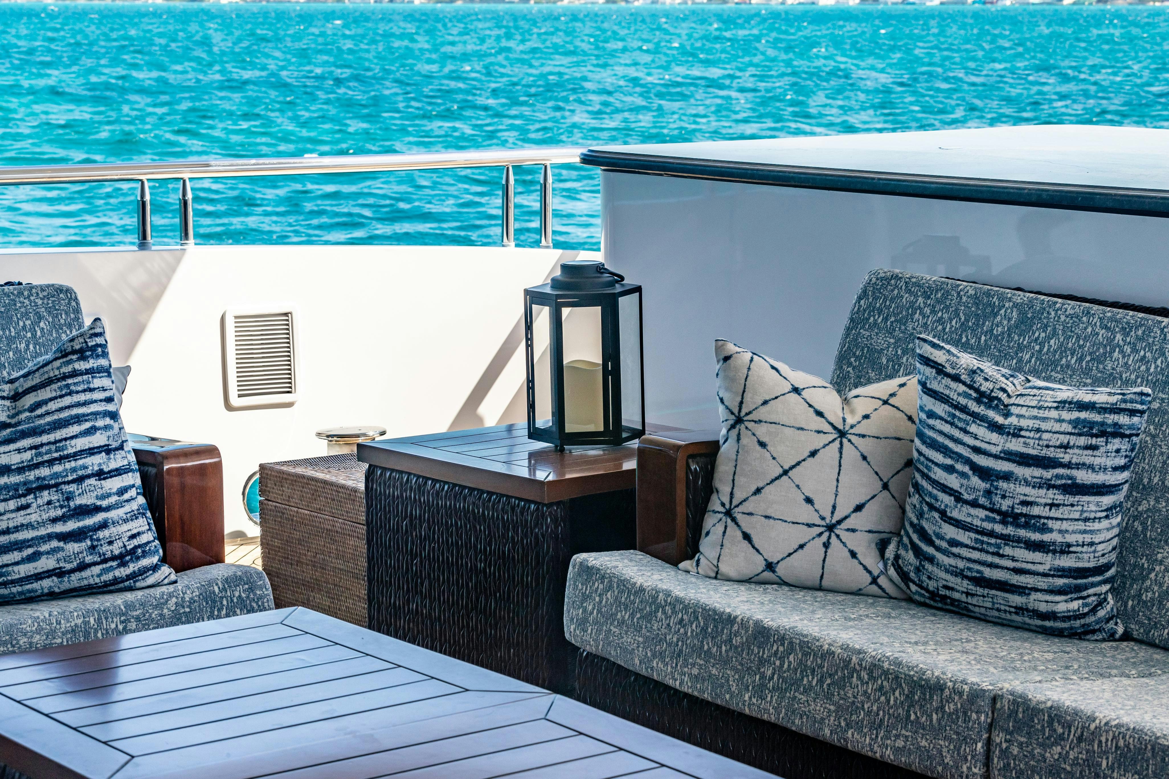 a white couch and a table on a boat aboard TCB Yacht for Charter