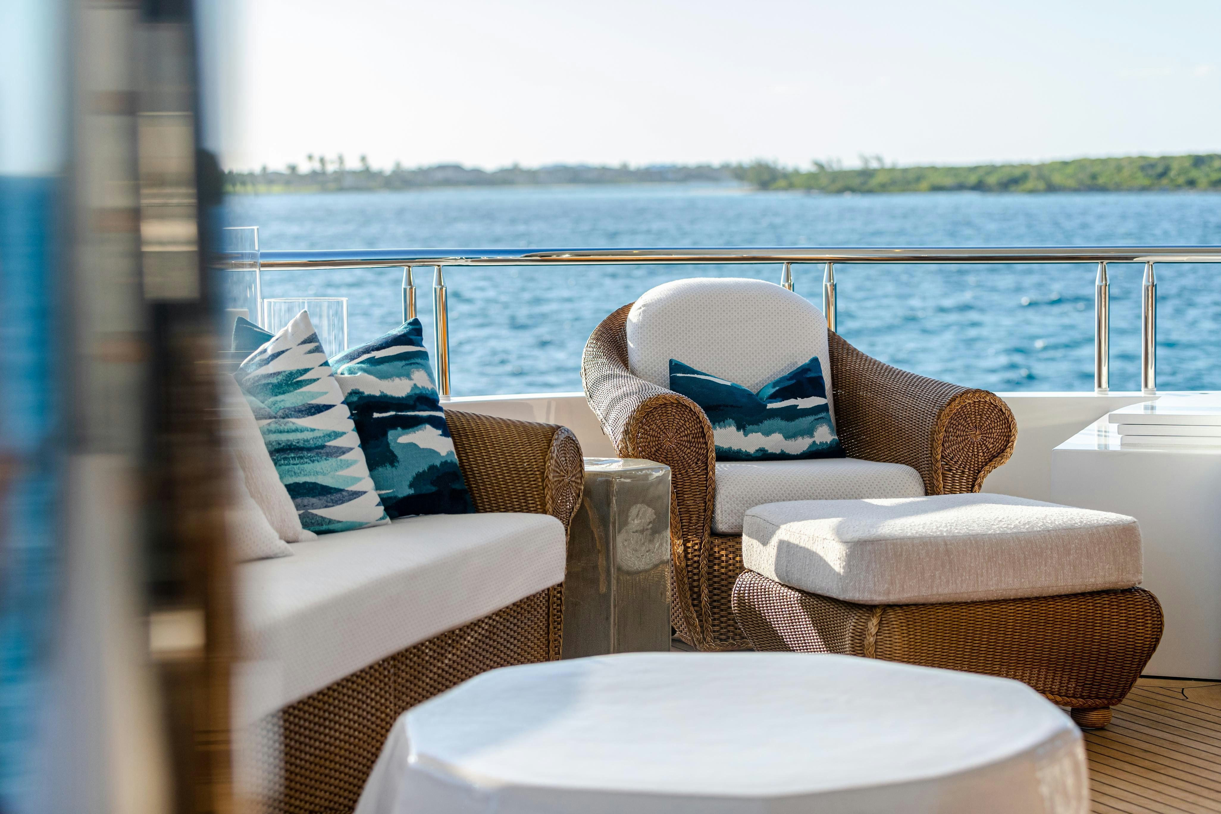 a group of chairs on a deck overlooking a body of water aboard TCB Yacht for Charter