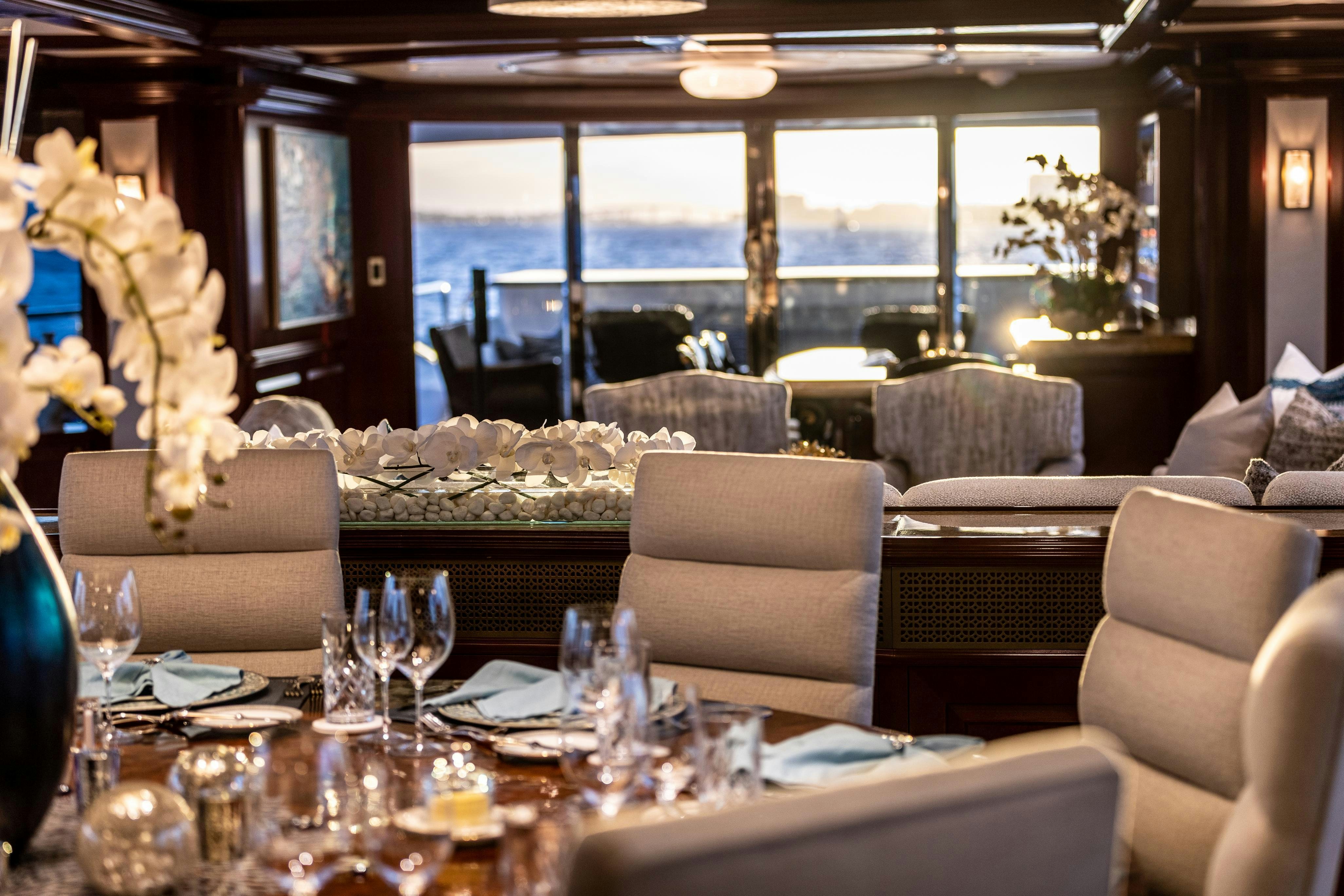 a room with a table chairs and a large window aboard TCB Yacht for Charter