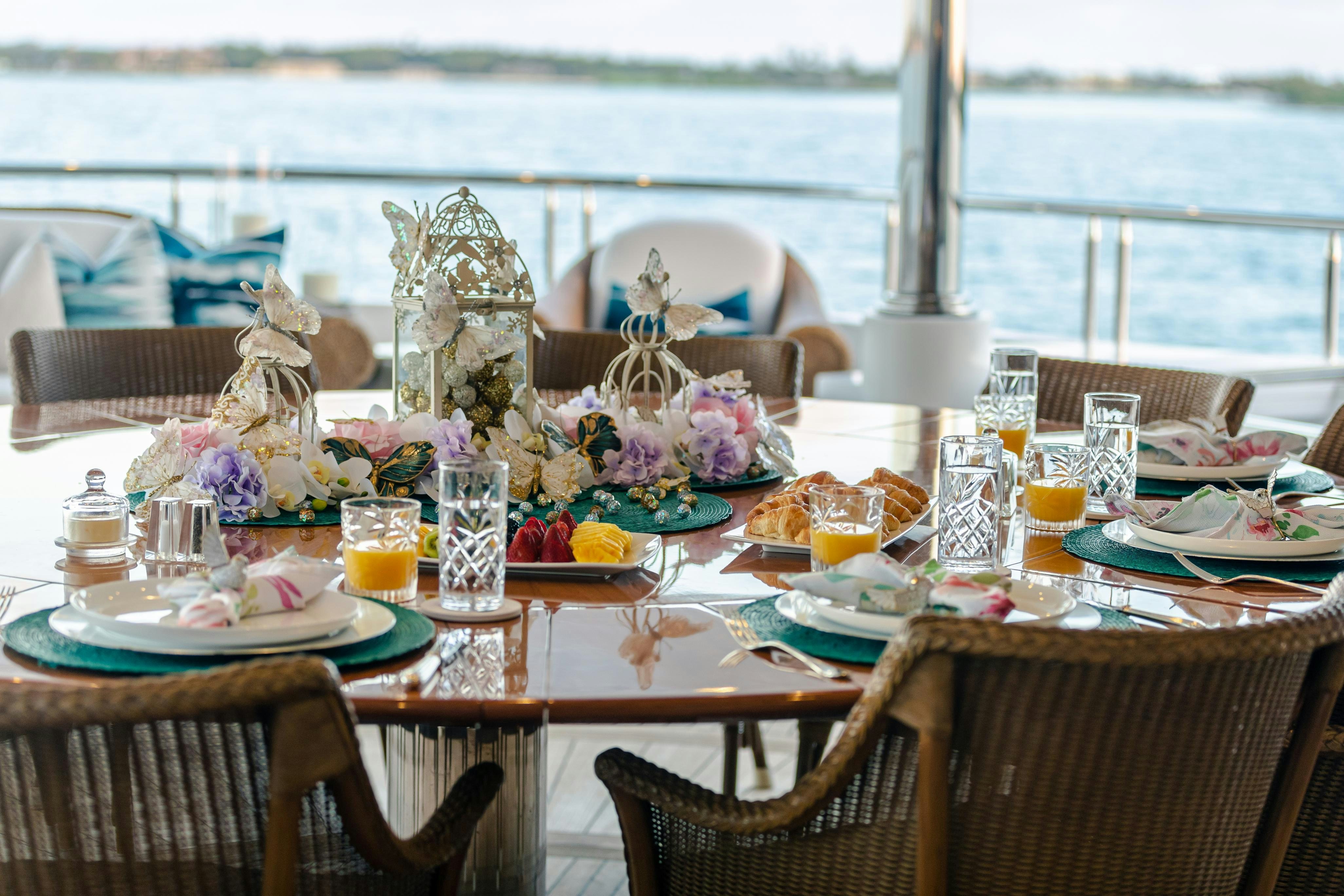 a table set with food and drinks aboard TCB Yacht for Charter