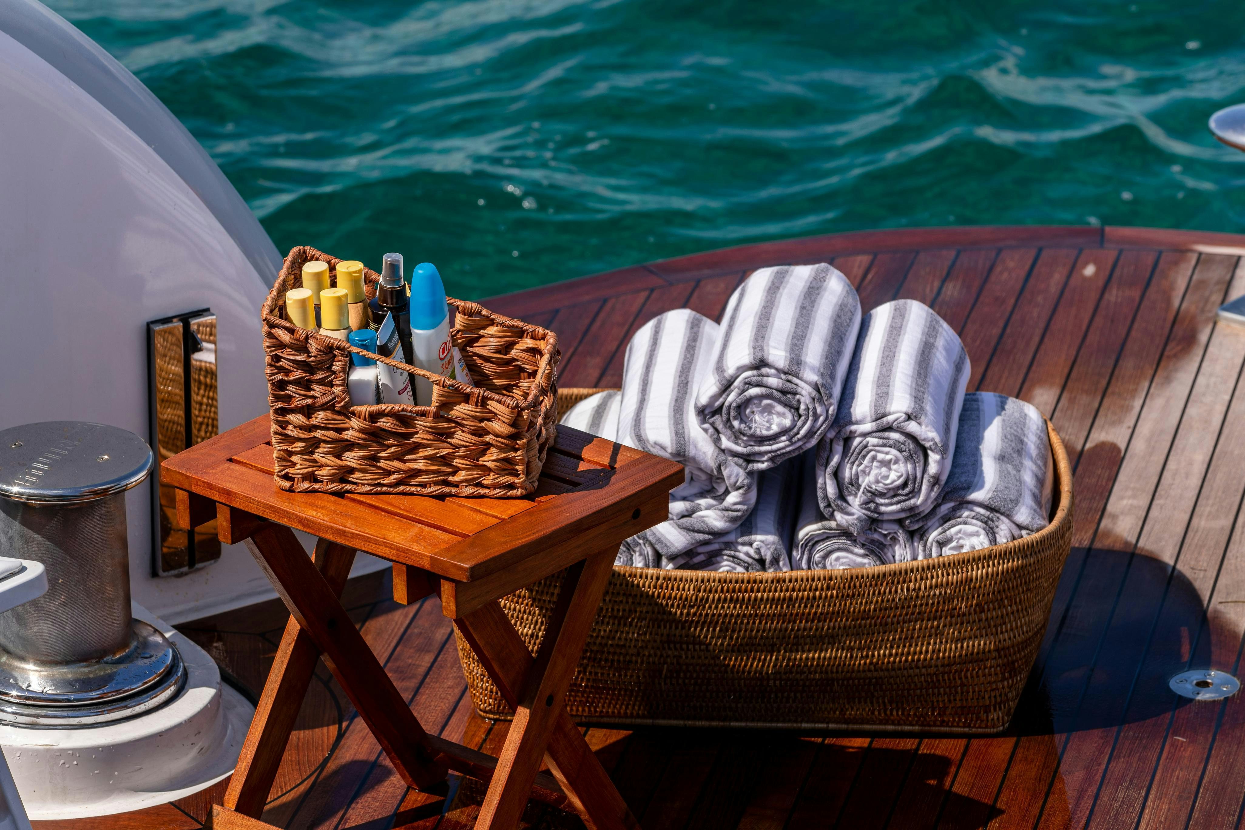 a picnic table with a basket of poker chips on it aboard TCB Yacht for Charter