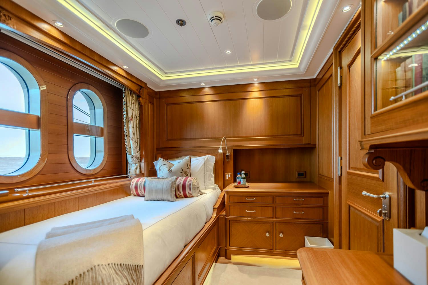 a room with a bed and a mirror aboard SEA OWL Yacht for Charter