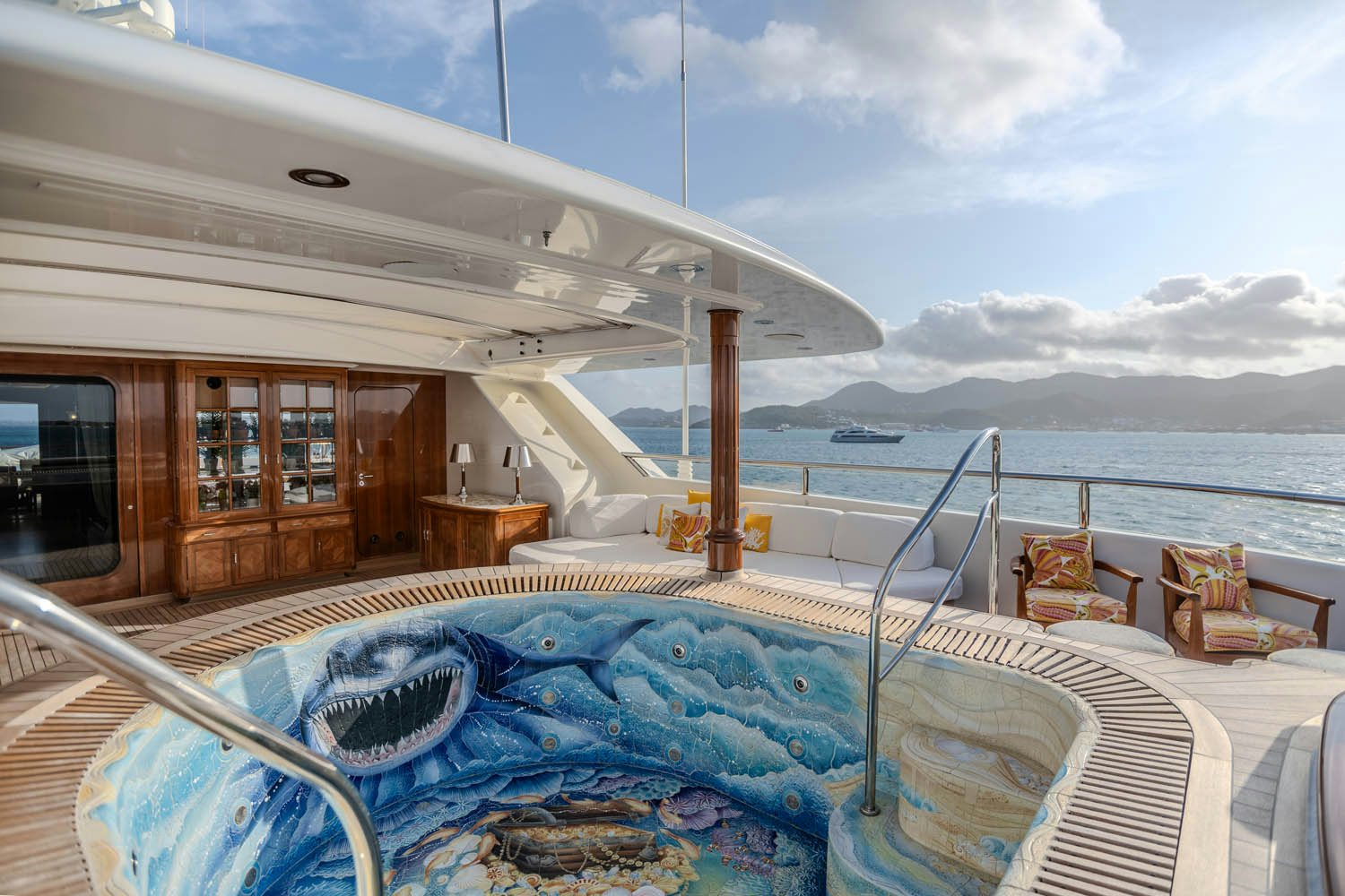 a deck with a view of the ocean and a boat aboard SEA OWL Yacht for Charter