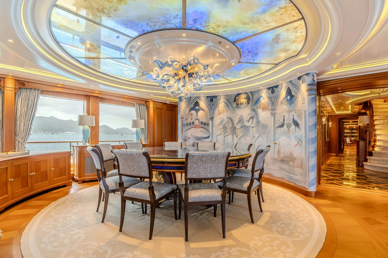 a dining room with a chandelier aboard SEA OWL Yacht for Charter