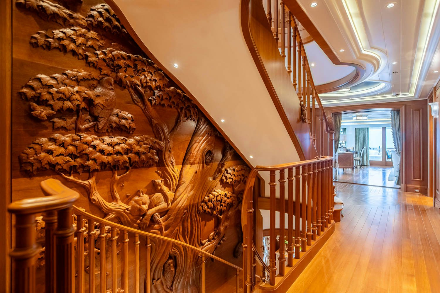 a staircase with a large painting on the wall aboard SEA OWL Yacht for Charter