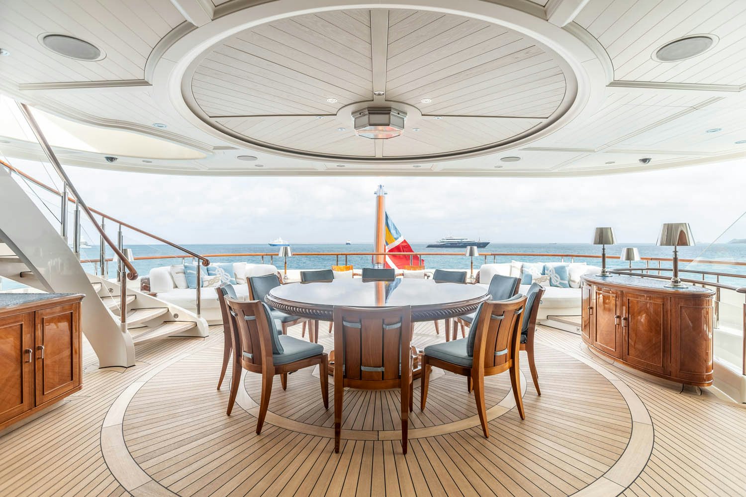 a large room with a table and chairs and a large pool aboard SEA OWL Yacht for Charter
