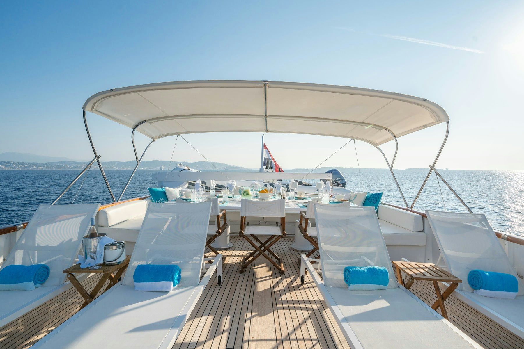 a deck with chairs and a large body of water in the background aboard AMMIRAGLIO Yacht for Sale