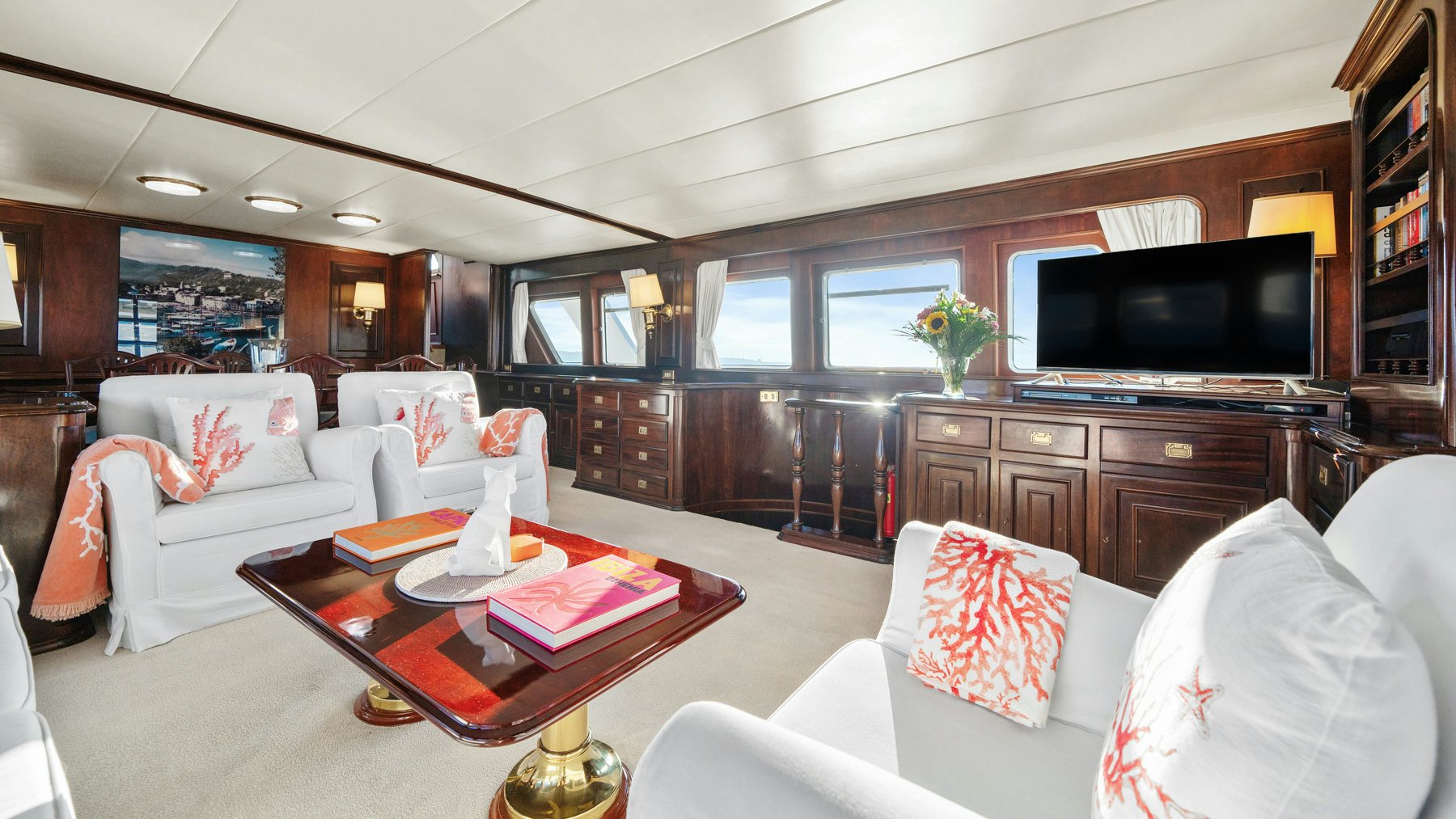 a living room with a tv and furniture aboard AMMIRAGLIO Yacht for Sale