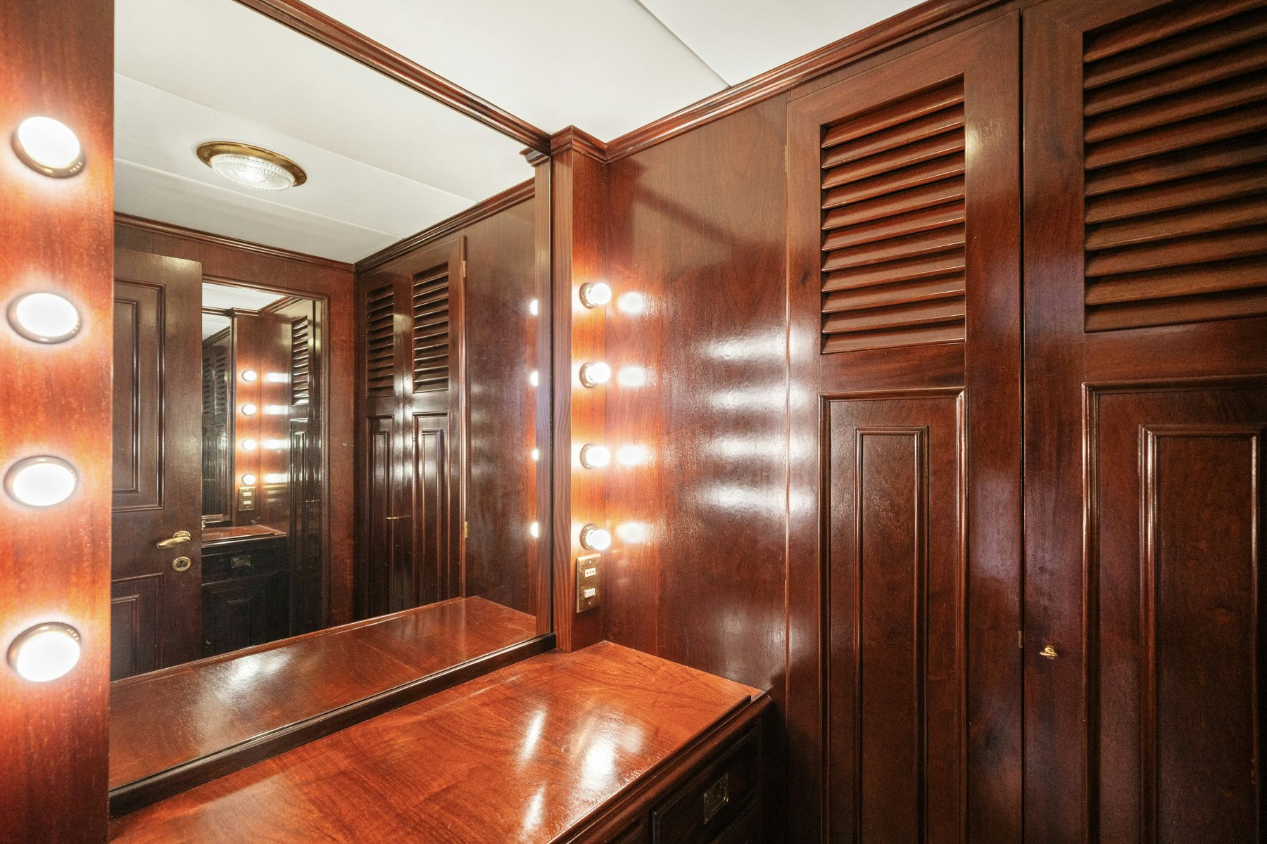 a bathroom with wooden cabinets aboard AMMIRAGLIO Yacht for Sale