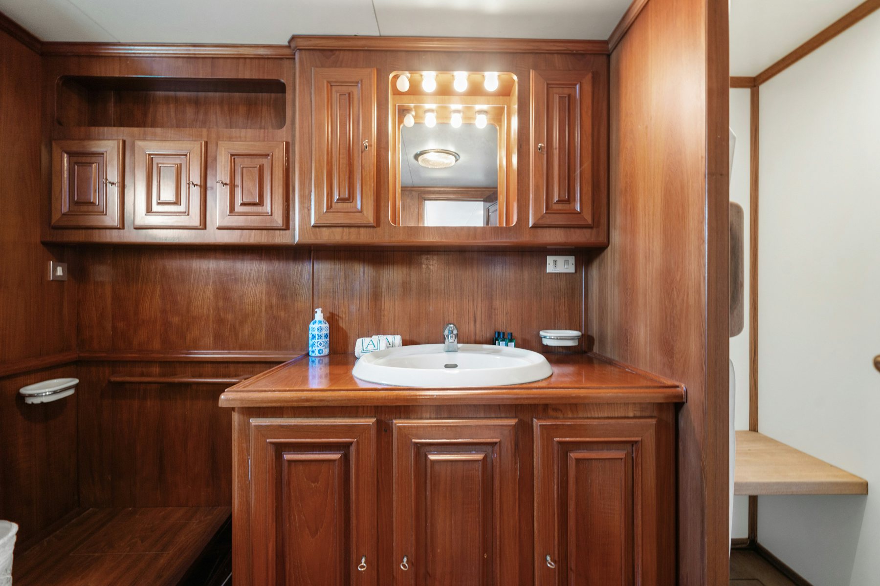 a kitchen with wooden cabinets aboard AMMIRAGLIO Yacht for Sale