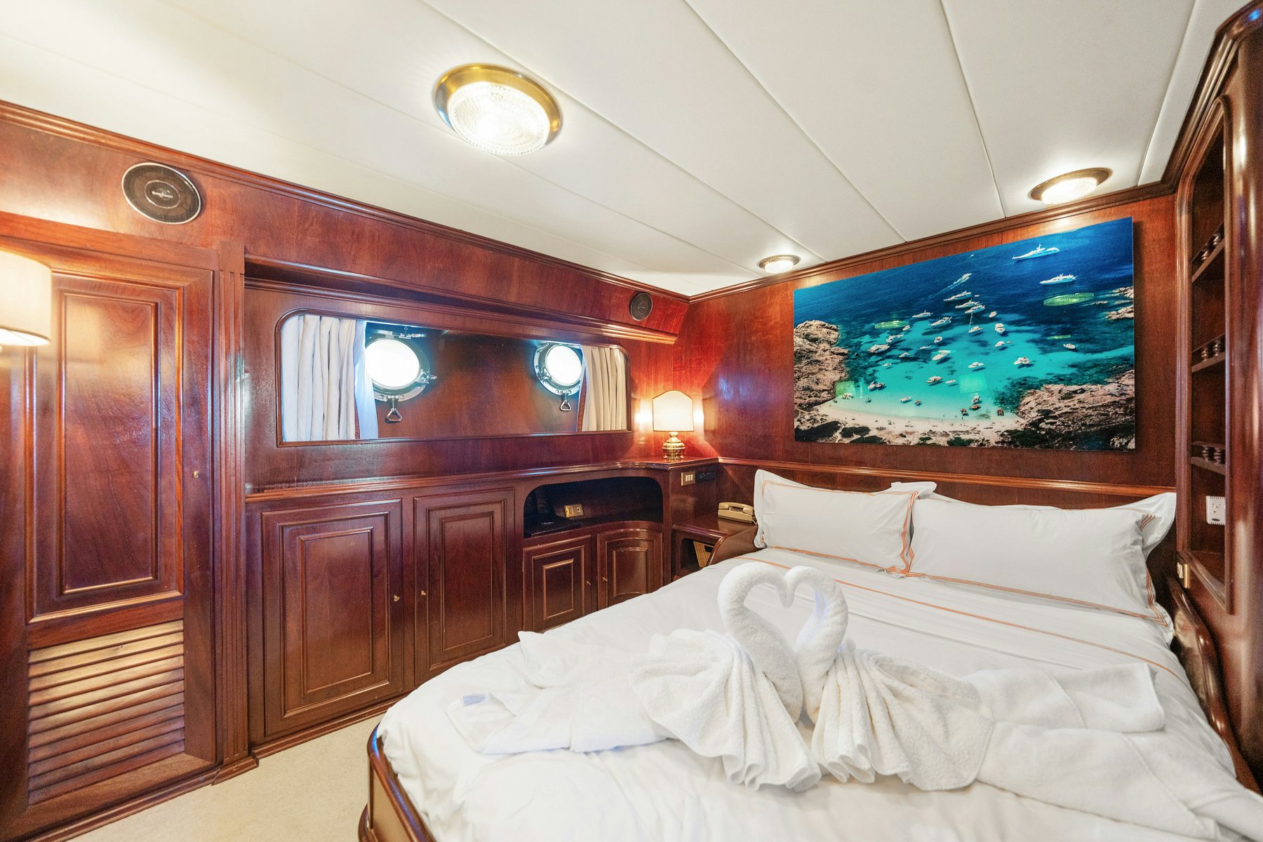 a bed with white sheets aboard AMMIRAGLIO Yacht for Sale