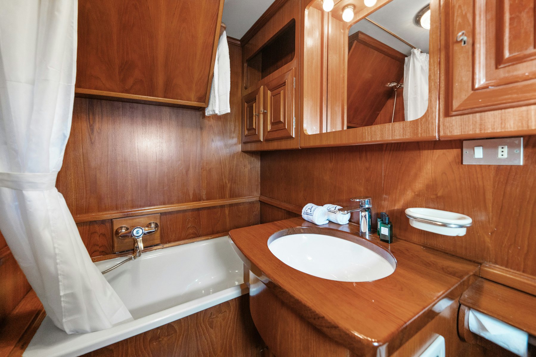 a bathroom with a sink and a bathtub aboard AMMIRAGLIO Yacht for Sale
