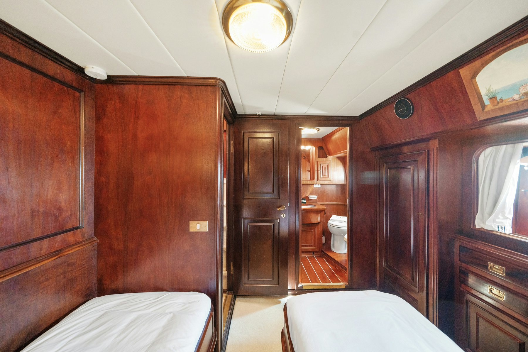 a bedroom with a wood cabinet aboard AMMIRAGLIO Yacht for Sale