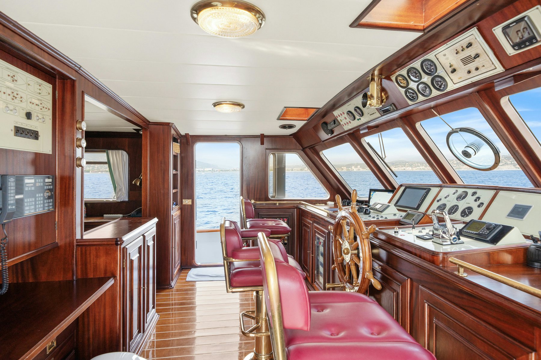 a large room with a table and chairs aboard AMMIRAGLIO Yacht for Sale