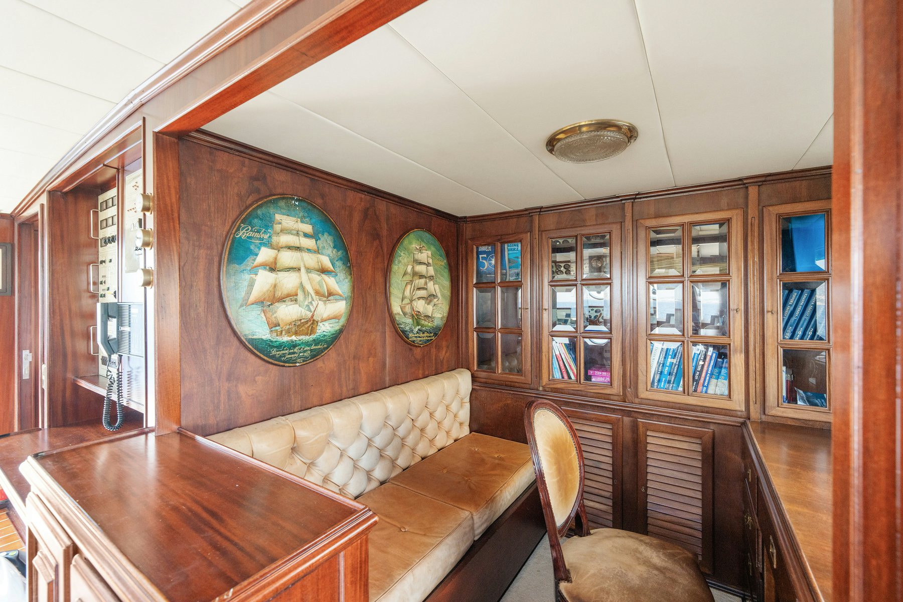 a room with a table and couch aboard AMMIRAGLIO Yacht for Sale