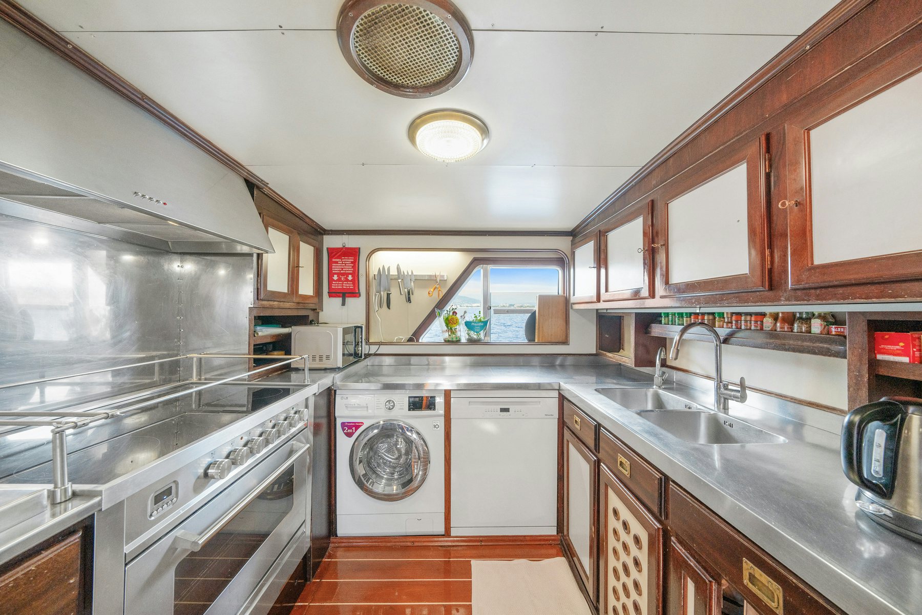 a kitchen with a washing machine aboard AMMIRAGLIO Yacht for Sale